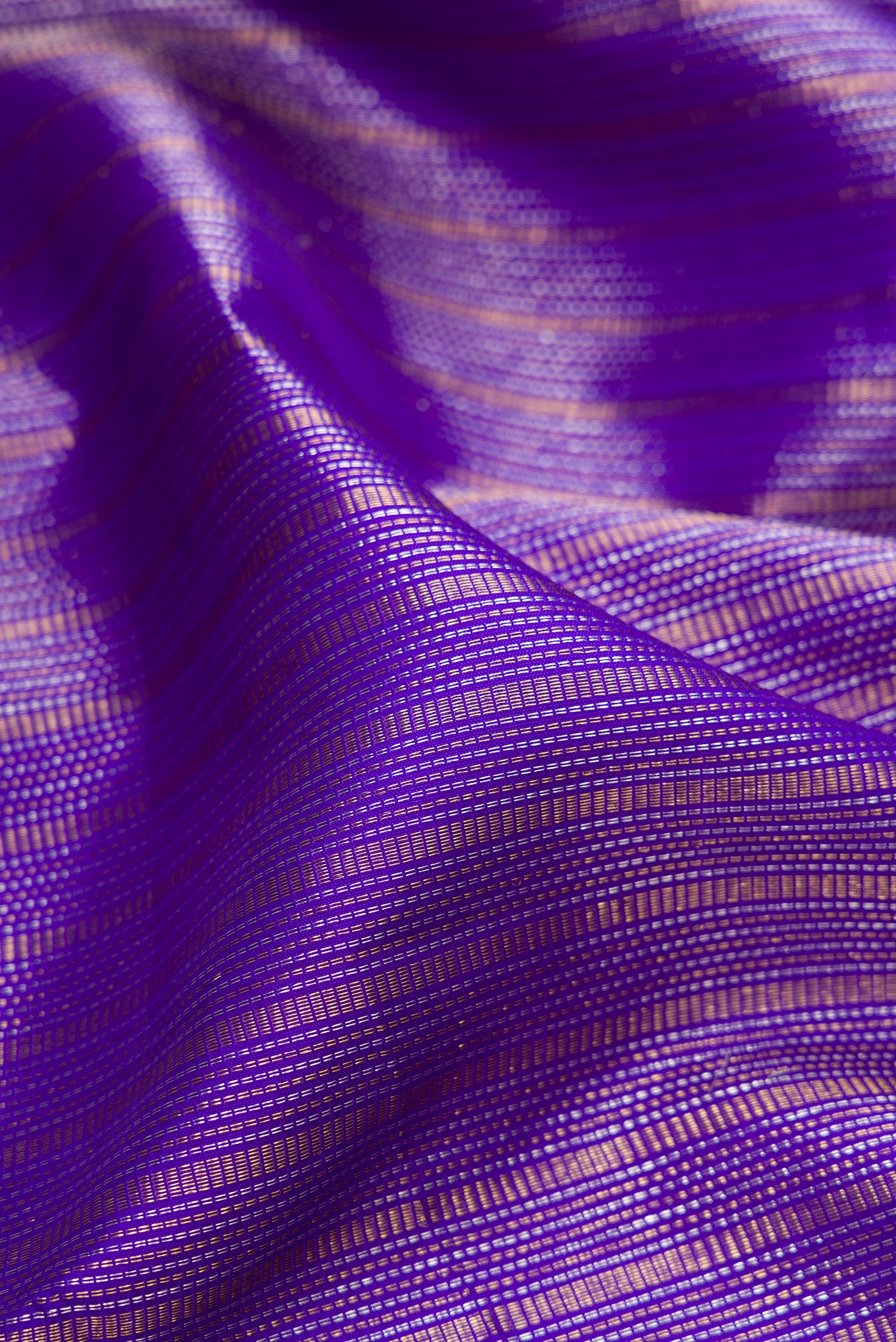 Close up of Violet Kanchipuram Silk Saree with Zari Brocade on the body and Zari Border.  displaying folds