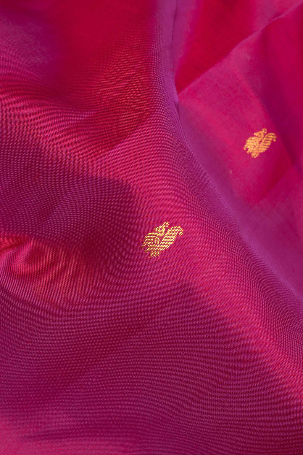 Close up of Pure Silk Magenta Kanchipuram Saree with Zari Butta on the body and Zari Border.  displaying folds