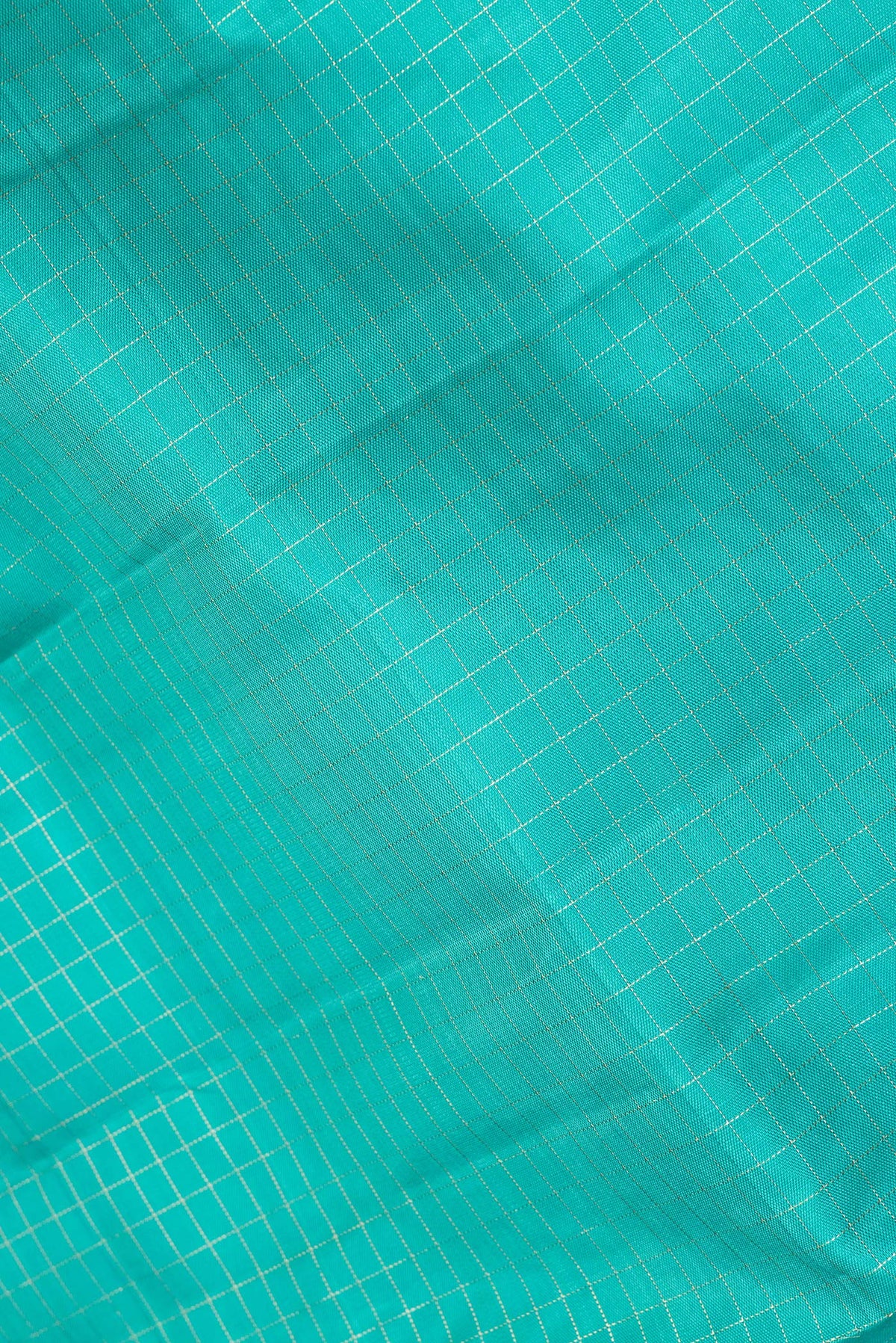 Close up of Pure Silk Sky Blue Dual Tone Kanchipuram Saree with Checked design on the body and Zari Border.  displaying folds