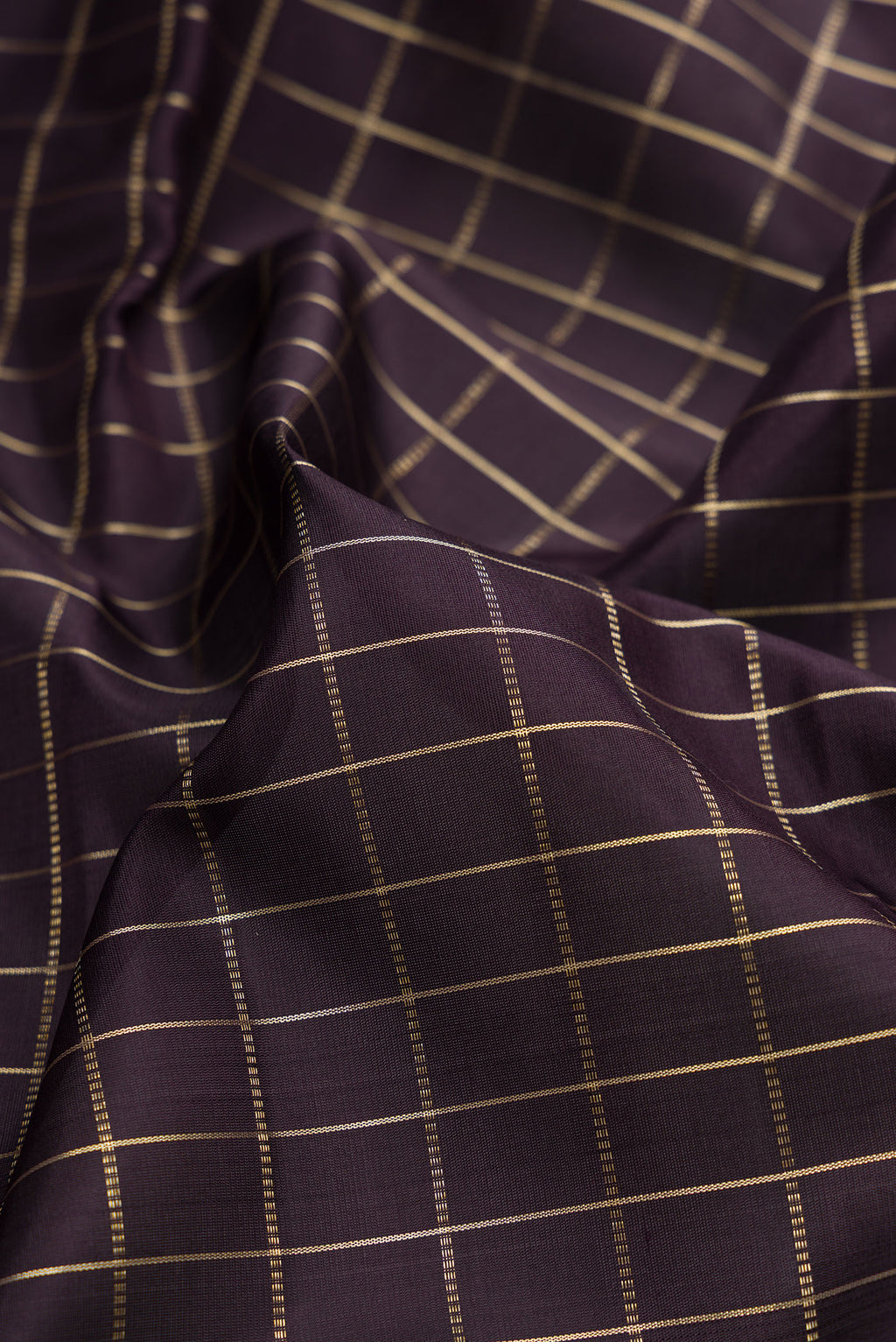 Close up of Coffee Brown Kanjivaram Silk Saree with Checked design on the body and Zari Border.  displaying folds
