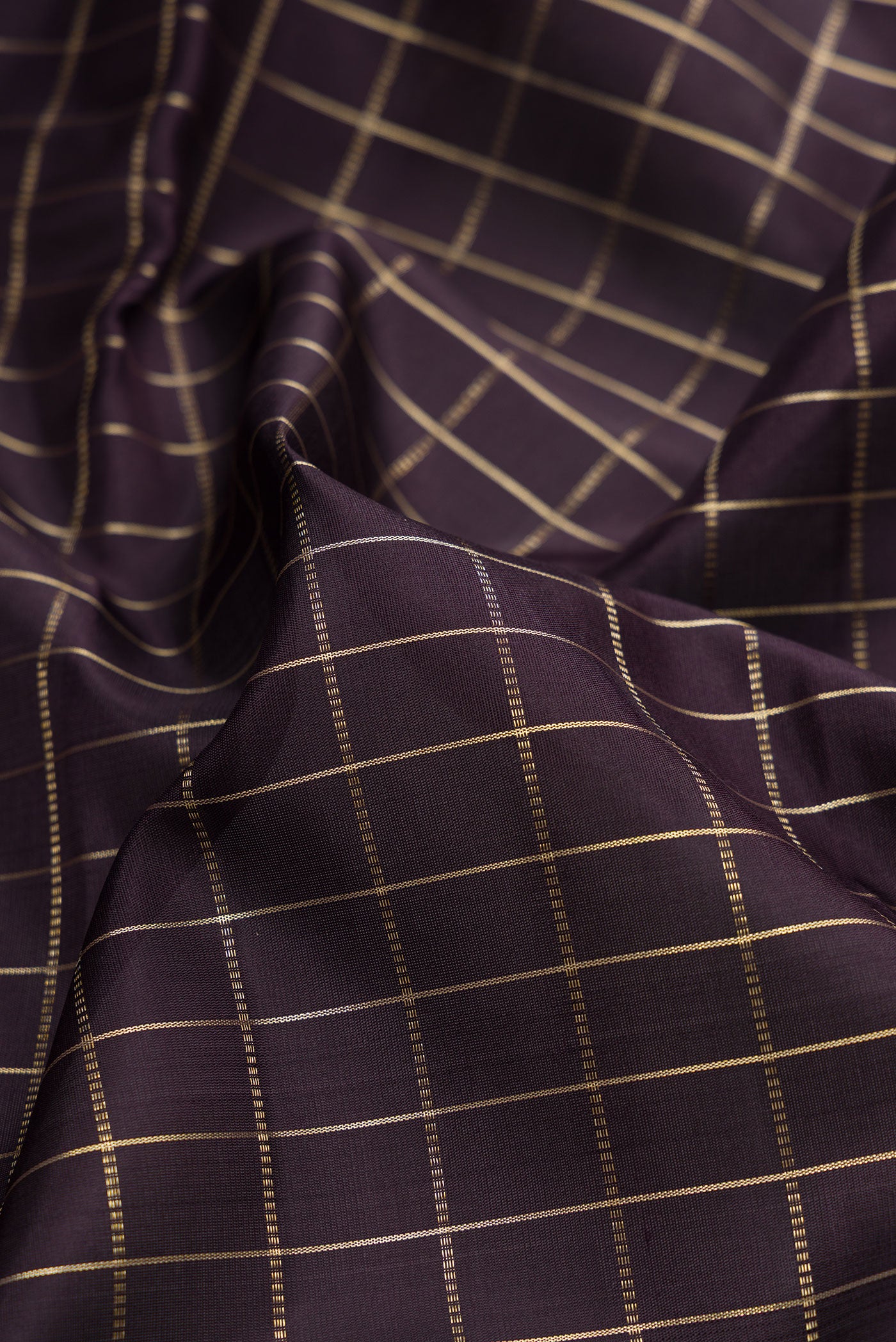Close up of Coffee Brown Kanjivaram Silk Saree with Checked design on the body and Zari Border.  displaying folds