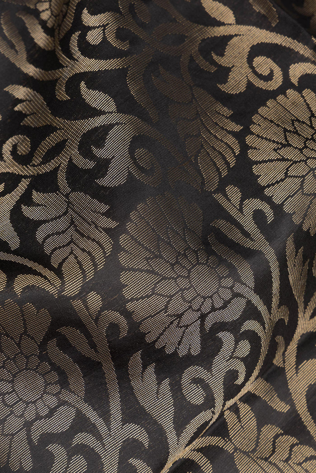 Close up of Pure Silk Black Dual Tone Soft Saree with Zari Brocade on the body and Fancy Border.  displaying folds