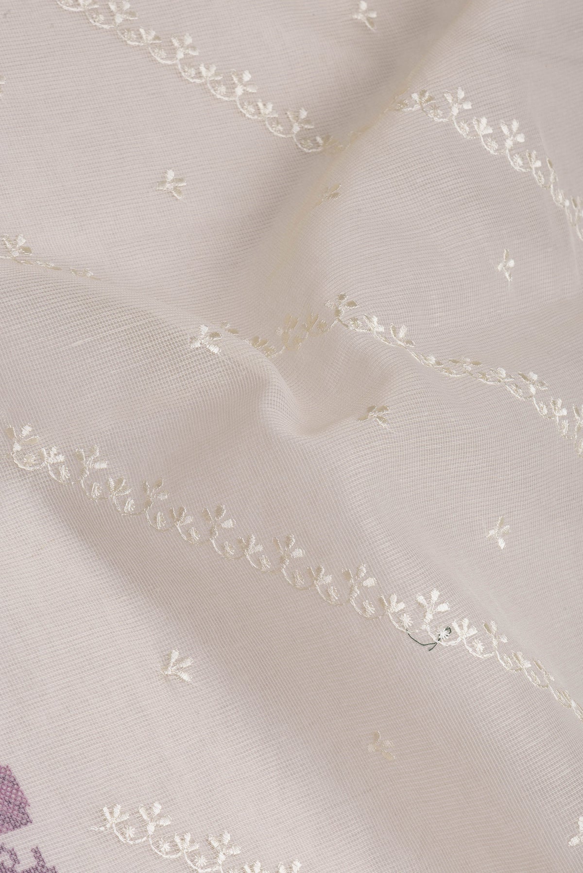 Close up of Cream Kota Silk Saree with Embroidery on the body and Embroidery Border.  displaying folds