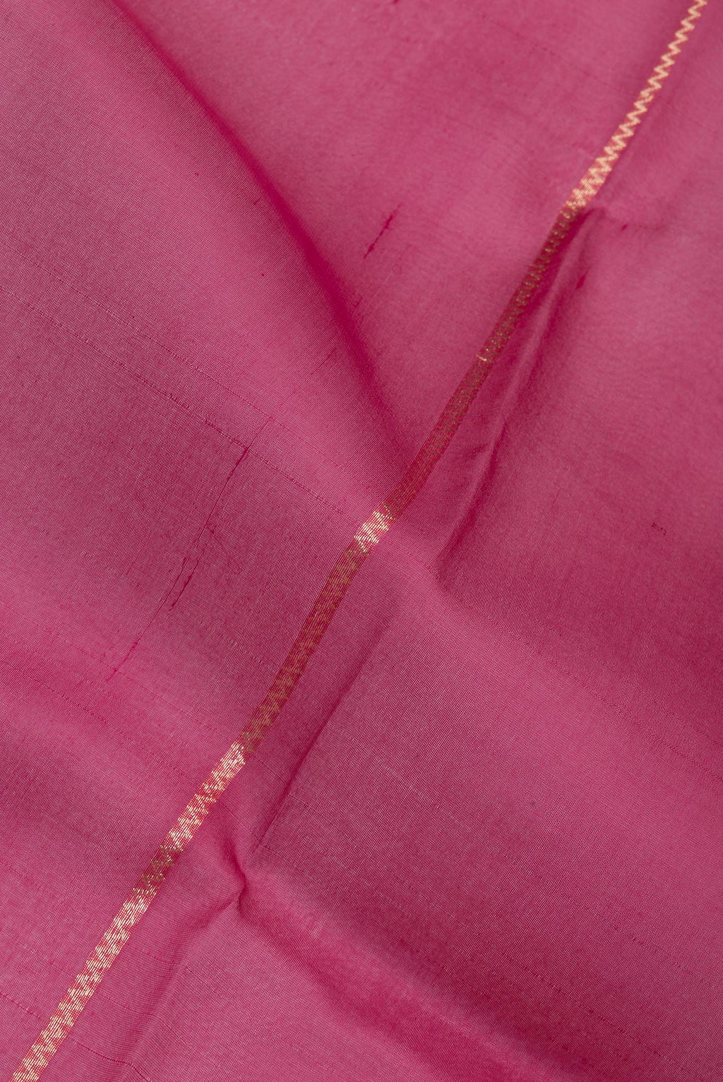 Close up of Dark Pink Organza Silk Saree with Stripes on the body and Zari Border.  displaying folds