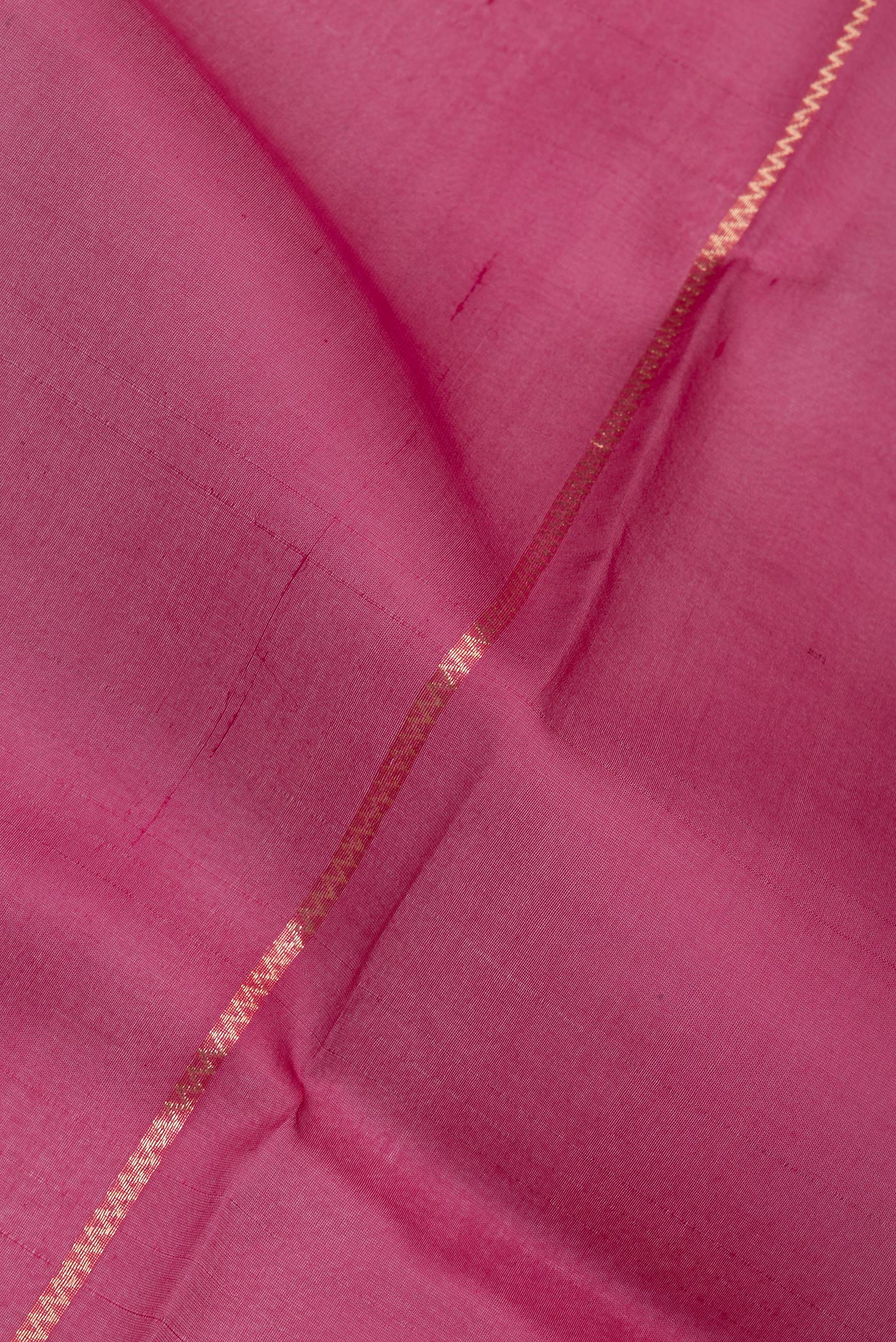 Close up of Dark Pink Organza Silk Saree with Stripes on the body and Zari Border.  displaying folds