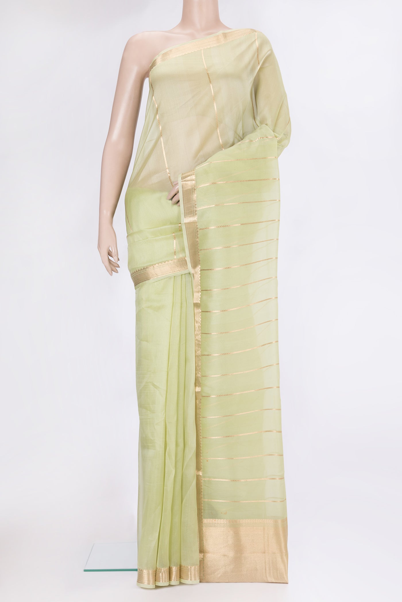 Pista Green Organza Silk Saree with Stripes on the body and Zari Border.  displayed on a mannequin