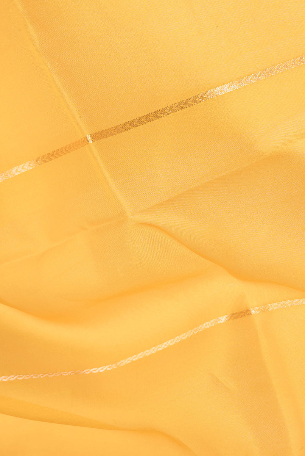 Close up of Yellow Organza Silk Saree with Stripes on the body and Zari Border.  displaying folds