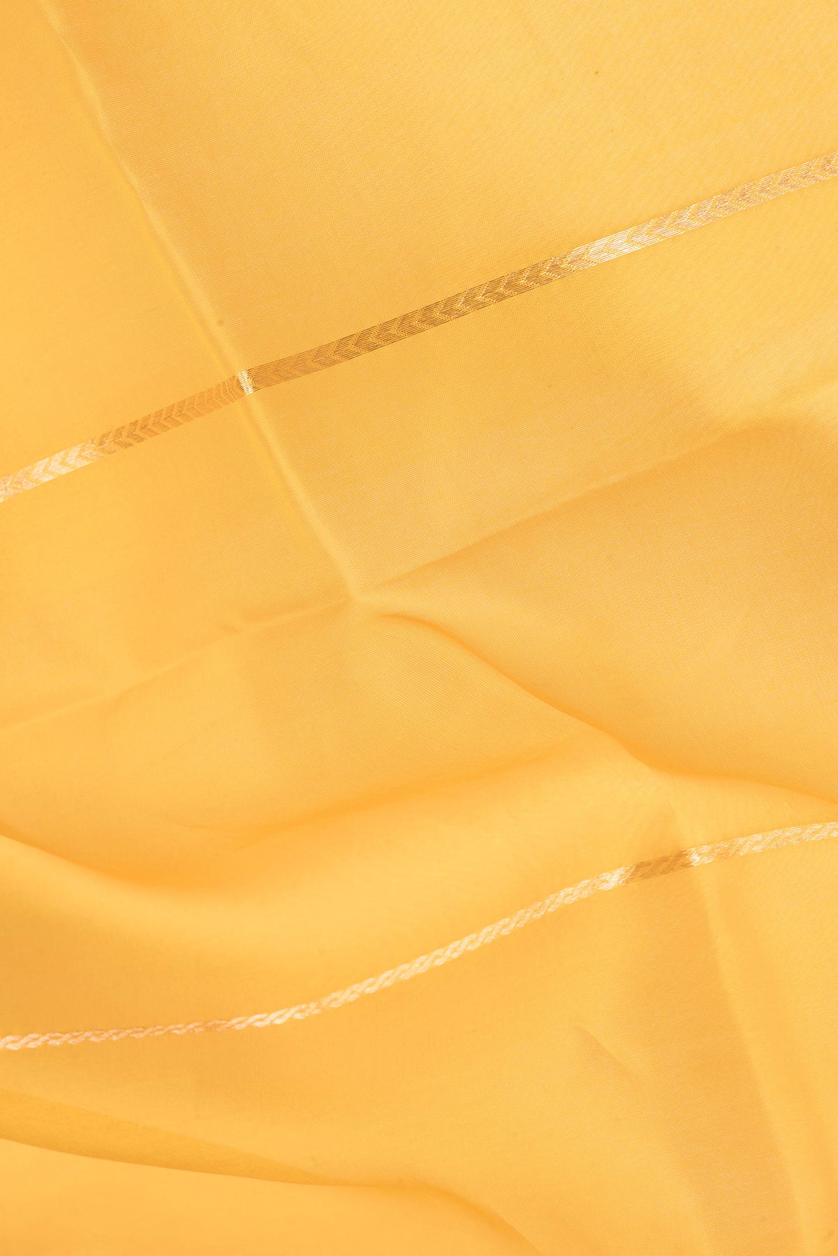 Close up of Yellow Organza Silk Saree with Stripes on the body and Zari Border.  displaying folds