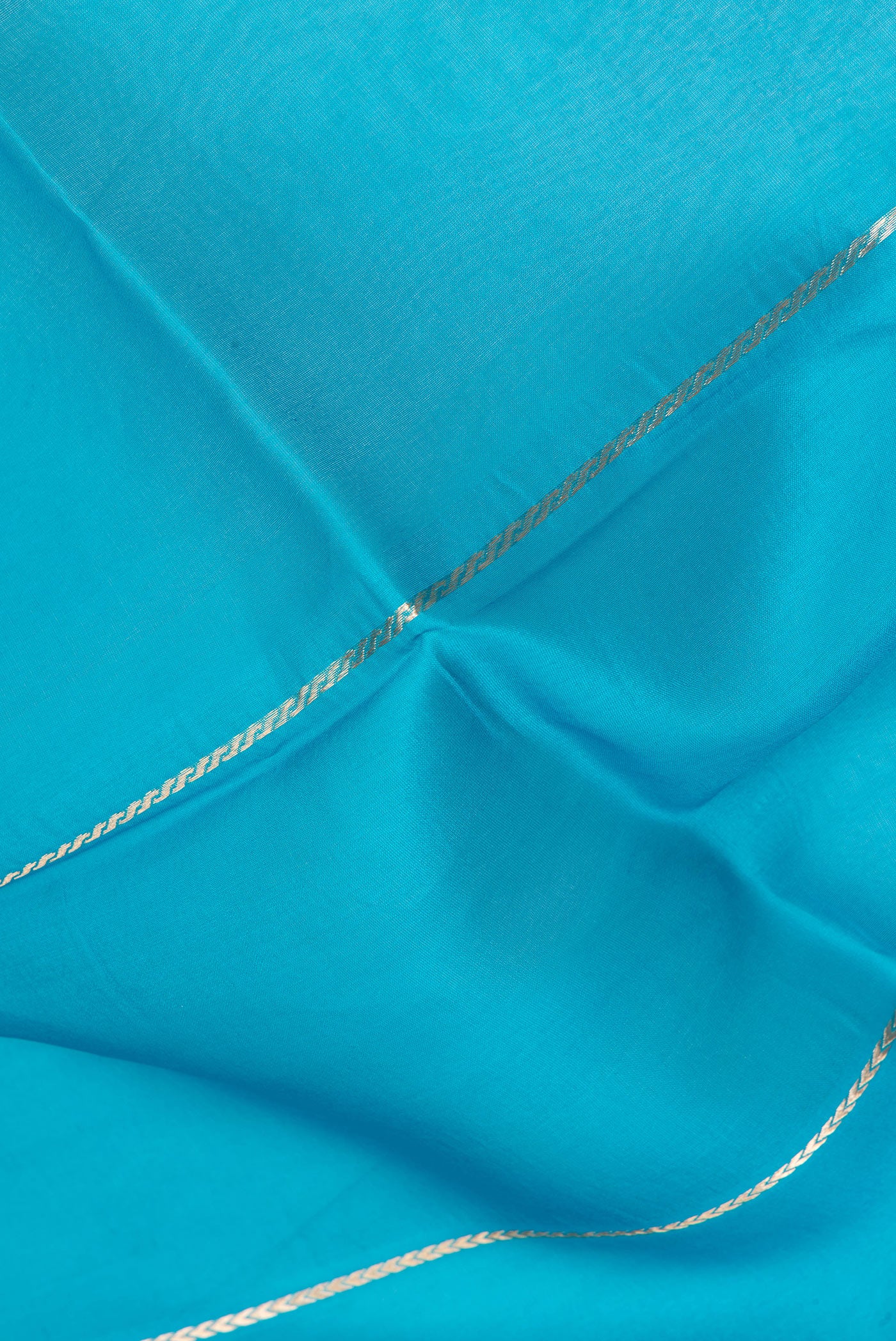 Close up of Sky Blue Organza Silk Saree with Stripes on the body and Zari Border.  displaying folds