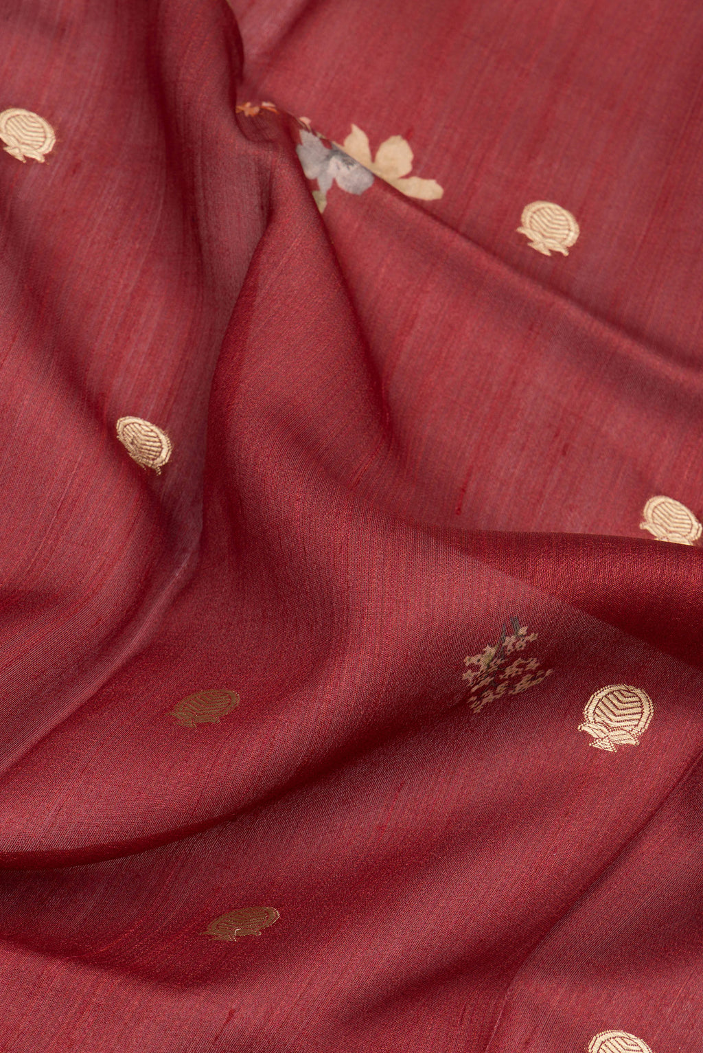 Close up of Maroon Tussar Silk Saree with Zari Butta on the body and Fancy Border.  displaying folds
