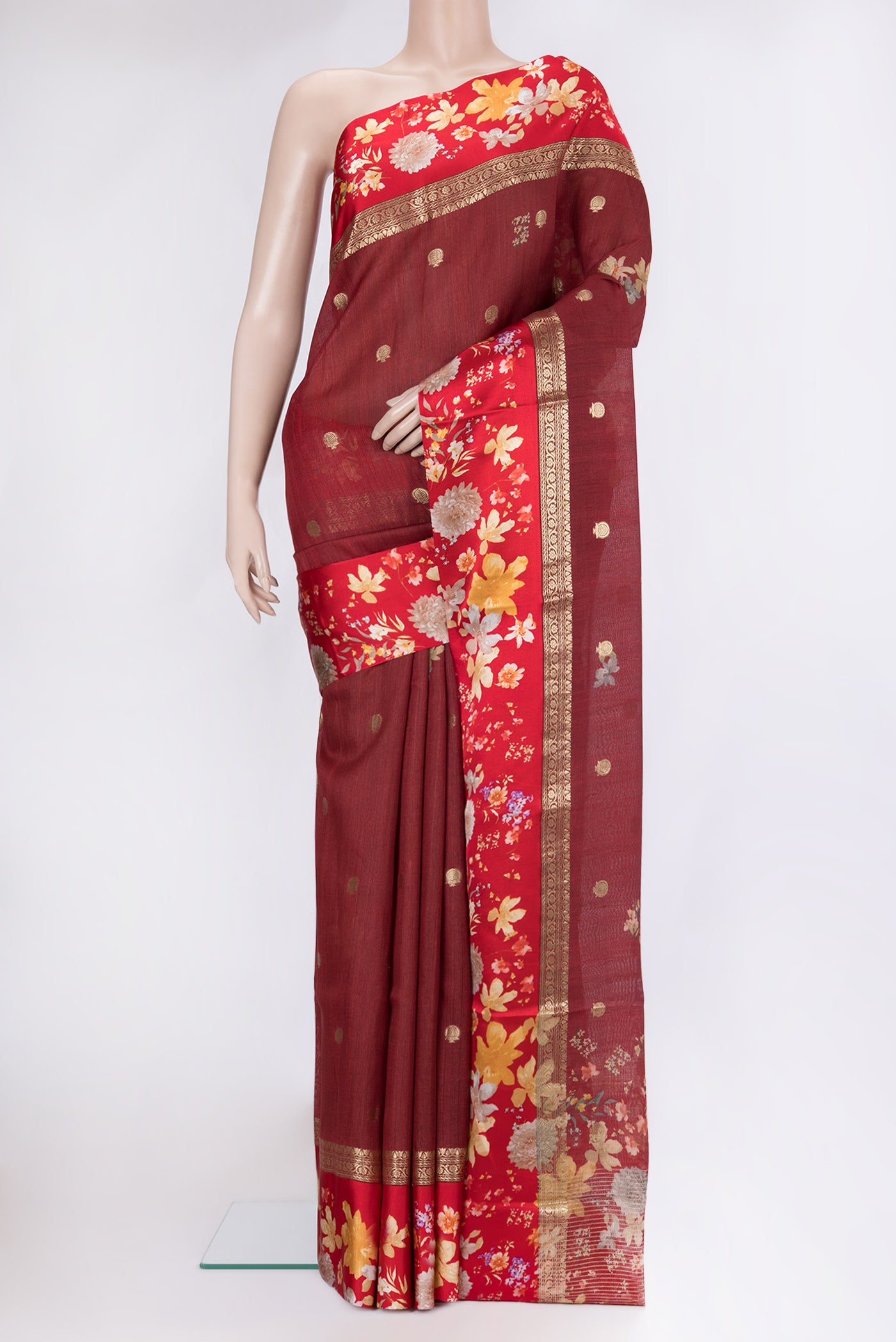 Maroon Tussar Silk Saree with Zari Butta on the body and Fancy Border.  displayed on a mannequin