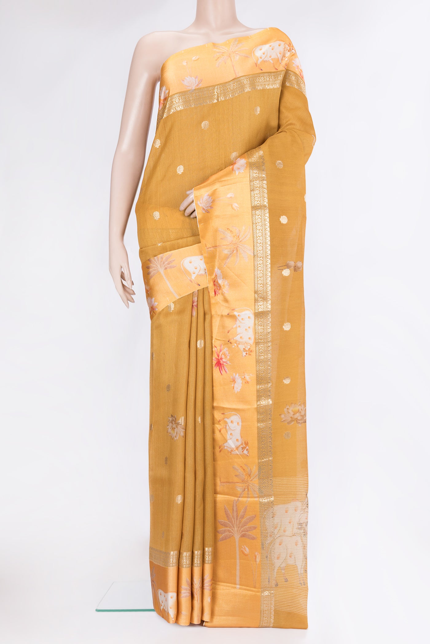 Mustard Tussar Silk Saree with Zari Butta on the body and Fancy Border.  displayed on a mannequin