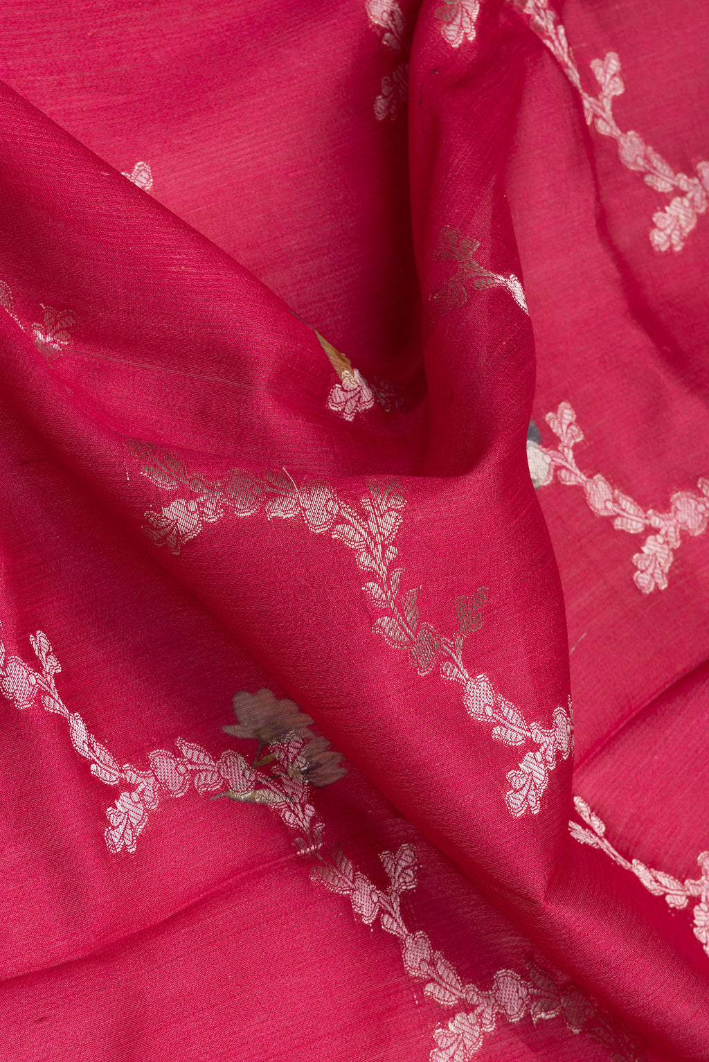 Close up of Dark Pink Tussar Silk Saree with Zari Brocade on the body and Fancy Border.  displaying folds