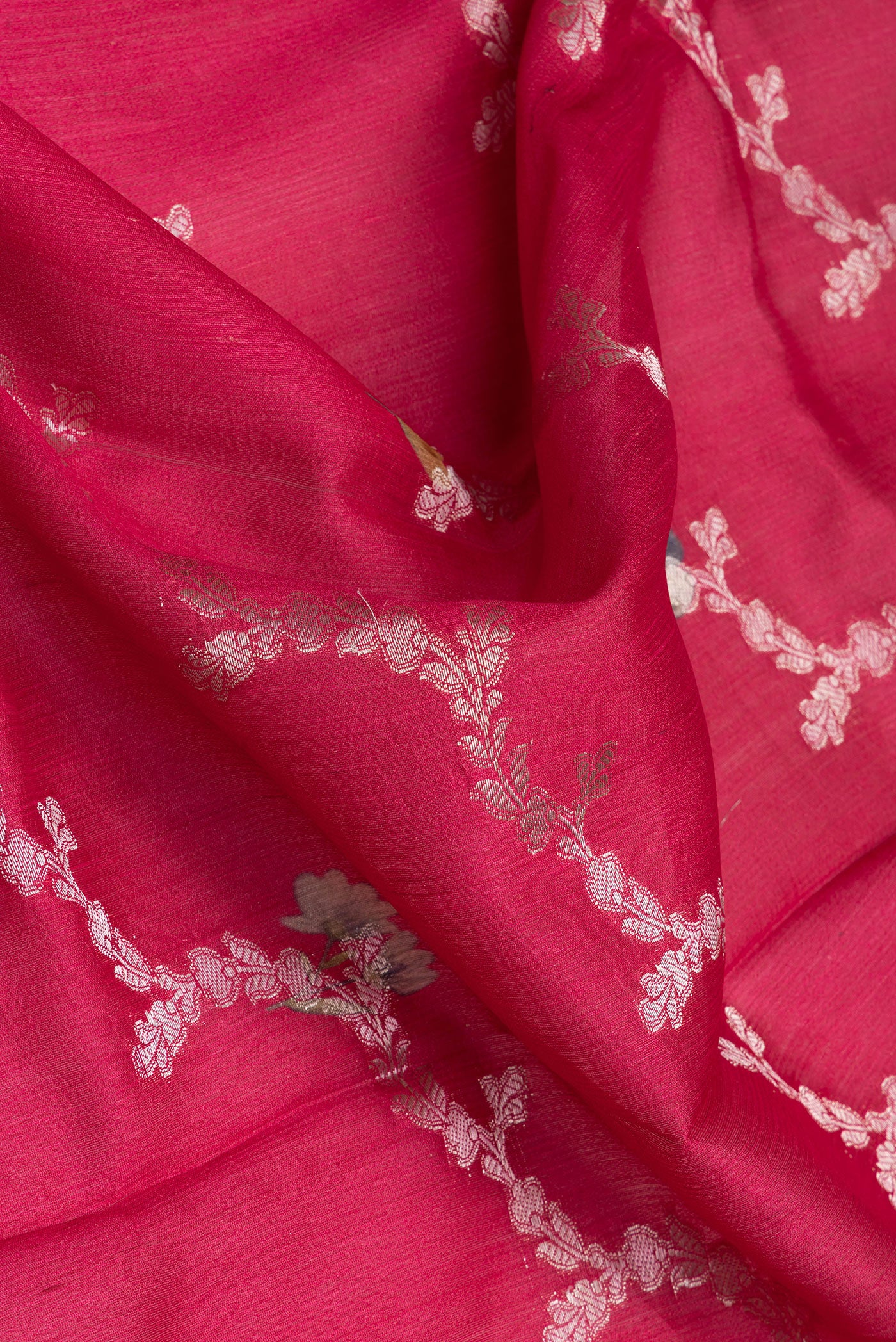 Close up of Dark Pink Tussar Silk Saree with Zari Brocade on the body and Fancy Border.  displaying folds