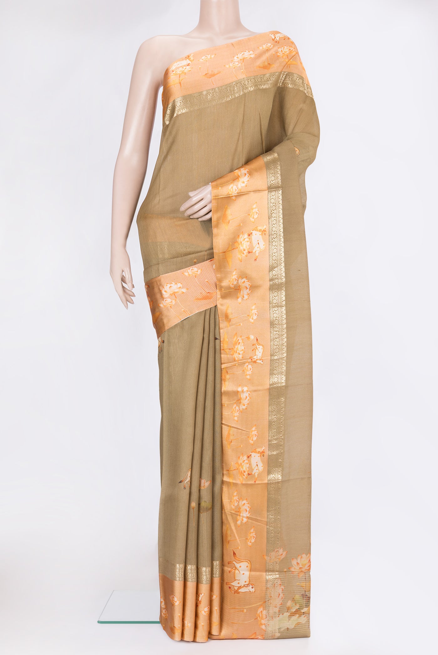 Dark Beige Tussar Silk Saree with Printed design on the body and Fancy Border.  displayed on a mannequin