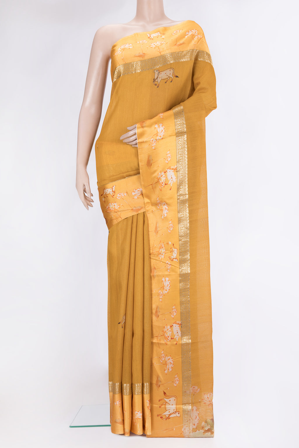 Mustard Tussar Silk Saree with Printed design on the body and Fancy Border.  displayed on a mannequin