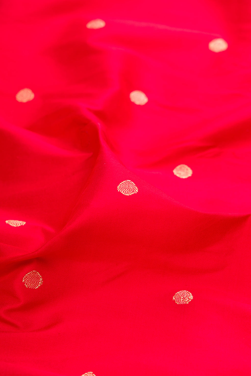 Close up of Red Dual Tone Paithani Silk Saree with Zari Butta on the body and Paithani Border.  displaying folds