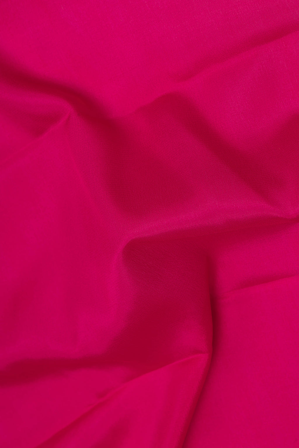 Close up of Dark Pink Mysore Silk Saree with Plain Body and Zari Border.  displaying folds