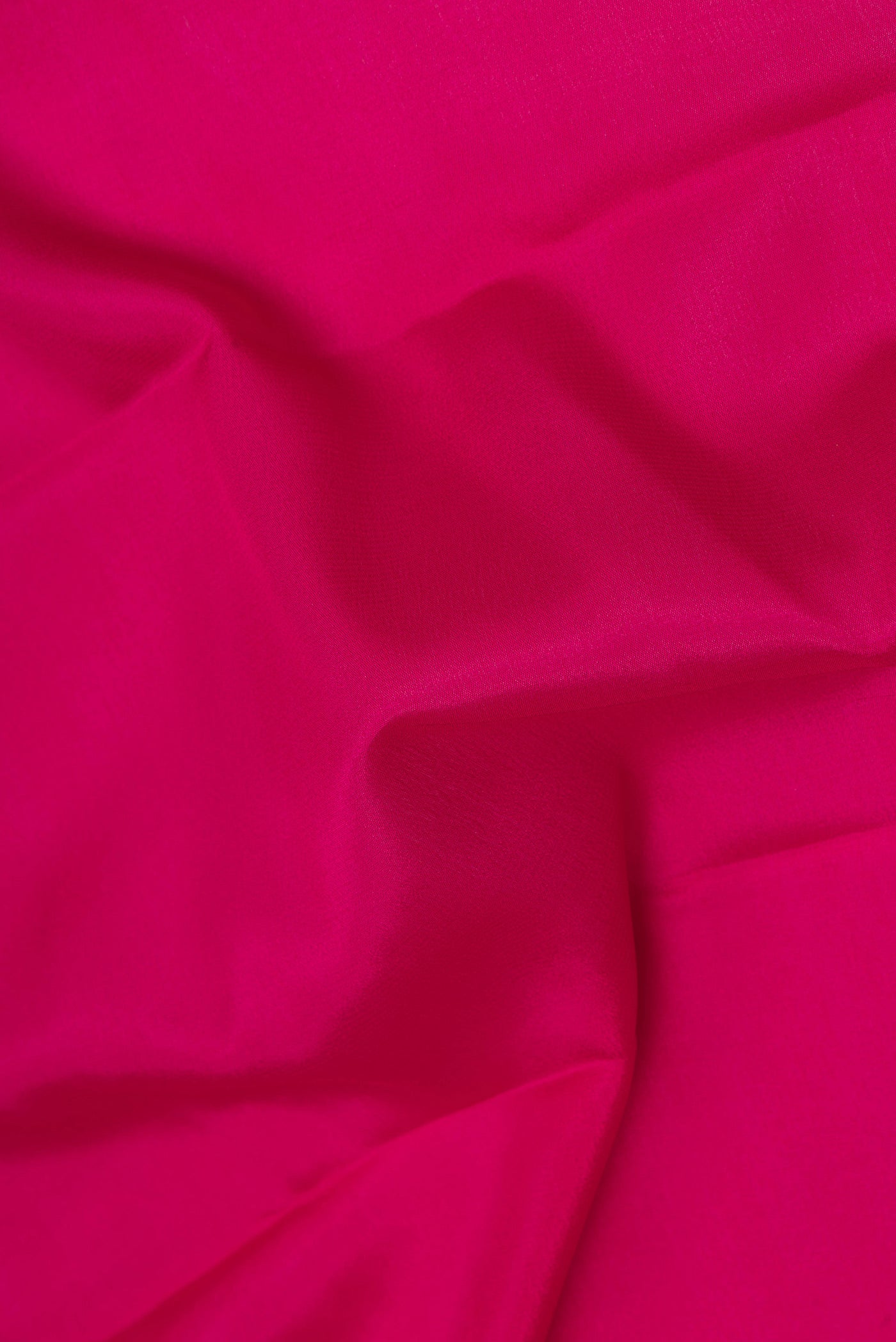 Close up of Dark Pink Mysore Silk Saree with Plain Body and Zari Border.  displaying folds