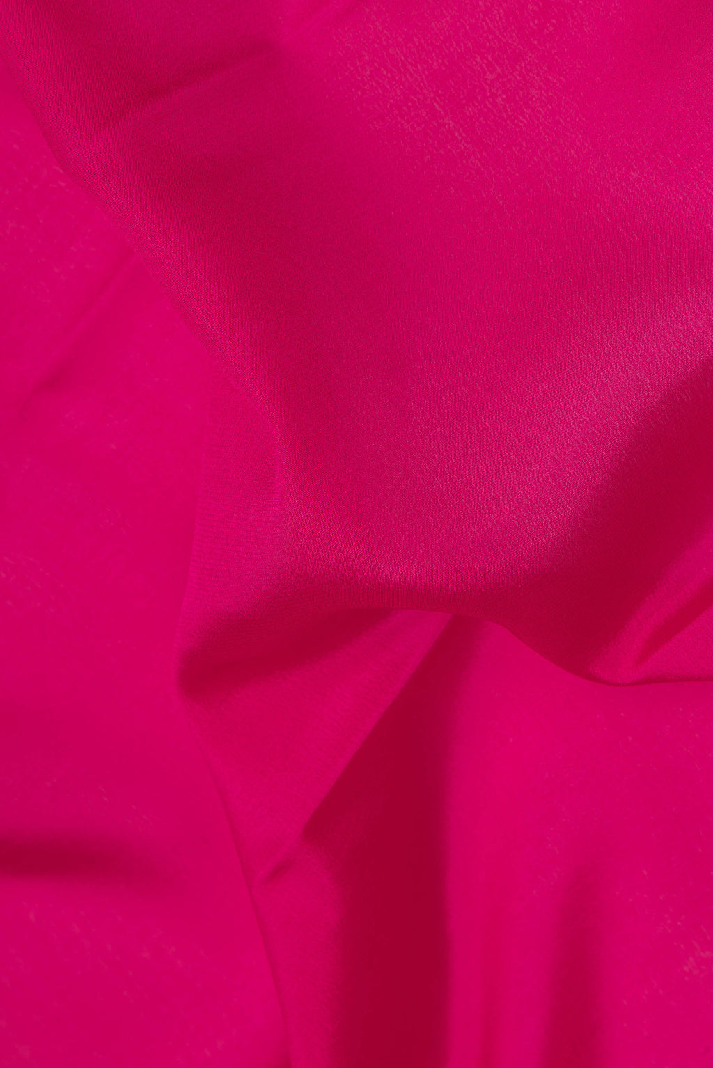 Close up of Dark Pink Mysore Crepe Saree with Plain Body and Zari Border.  displaying folds