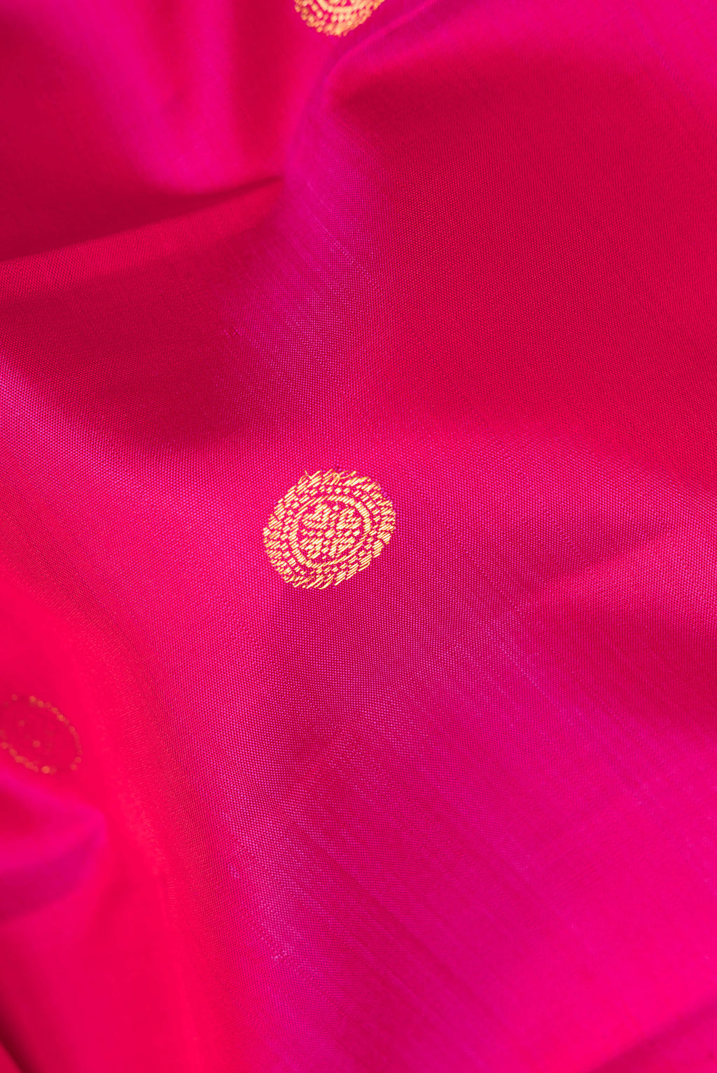 Close up of Pure Silk Pink Kanjivaram Saree with Zari Butta on the body and Fancy Border.  displaying folds