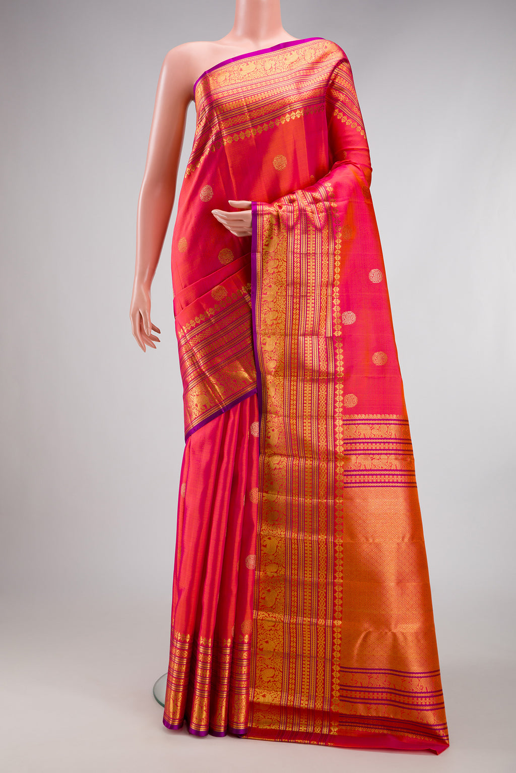 Pink with Orange Color Kanjivaram Silk Saree with Zari Butta on the body and Fancy Border.  displayed on a mannequin