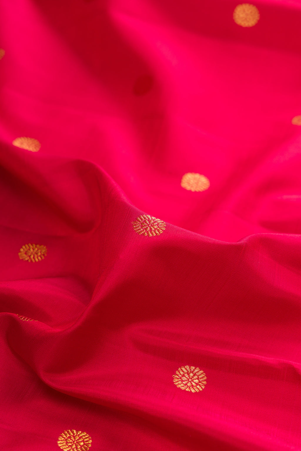 Close up of Pure Silk Red Kanjivaram Saree with Zari Butta on the body and Temple Border.  displaying folds