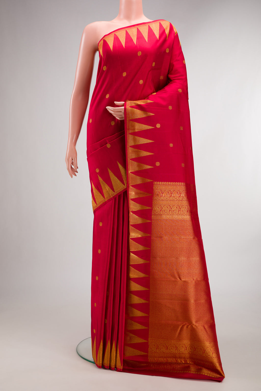 Pure Silk Red Kanjivaram Saree with Zari Butta on the body and Temple Border.  displayed on a mannequin