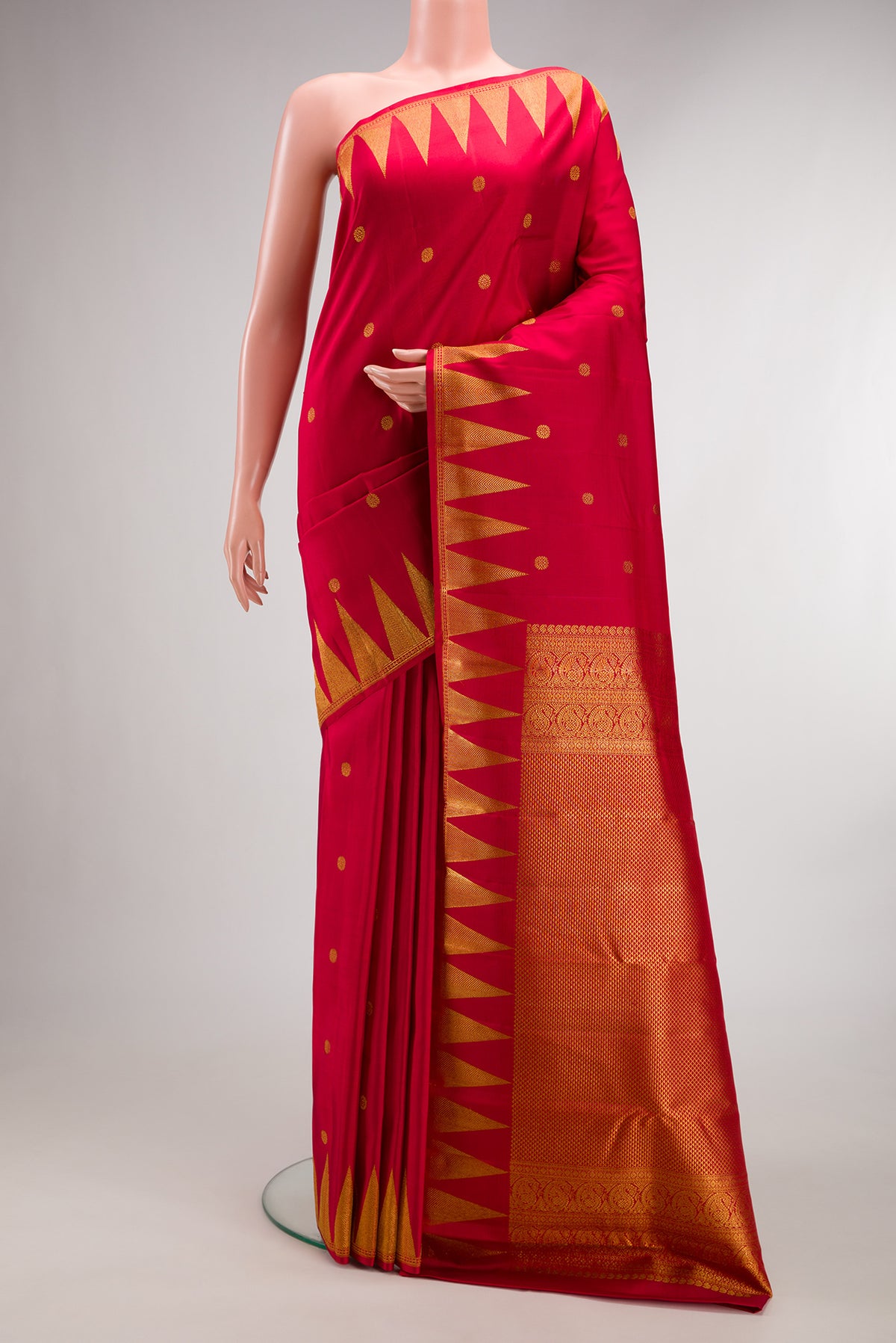 Pure Silk Red Kanjivaram Saree with Zari Butta on the body and Temple Border.  displayed on a mannequin