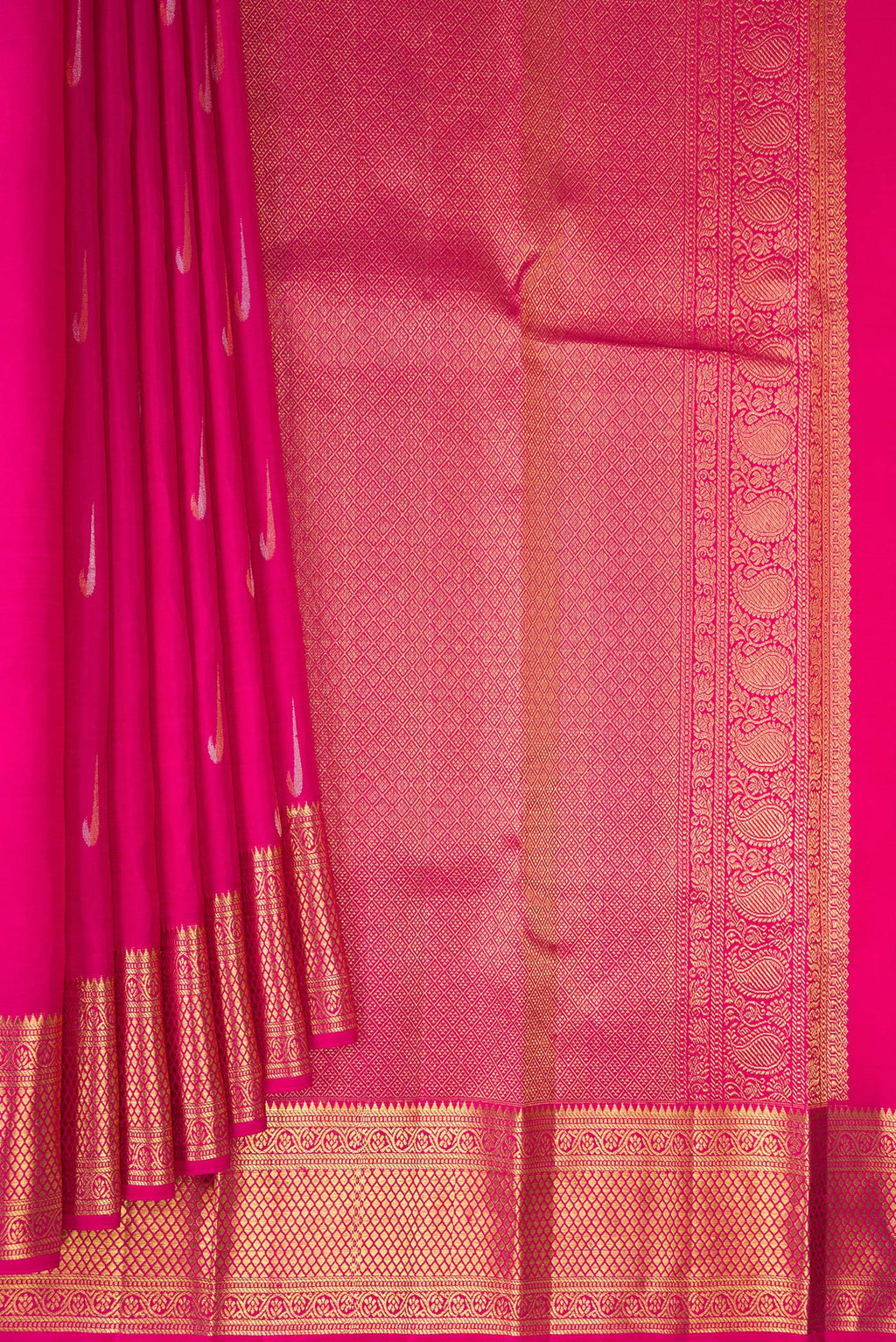 Pleats and pallu of Pure Silk Rani Pink Kanchipuram Saree with Zari Butta on the body and Zari Border. 