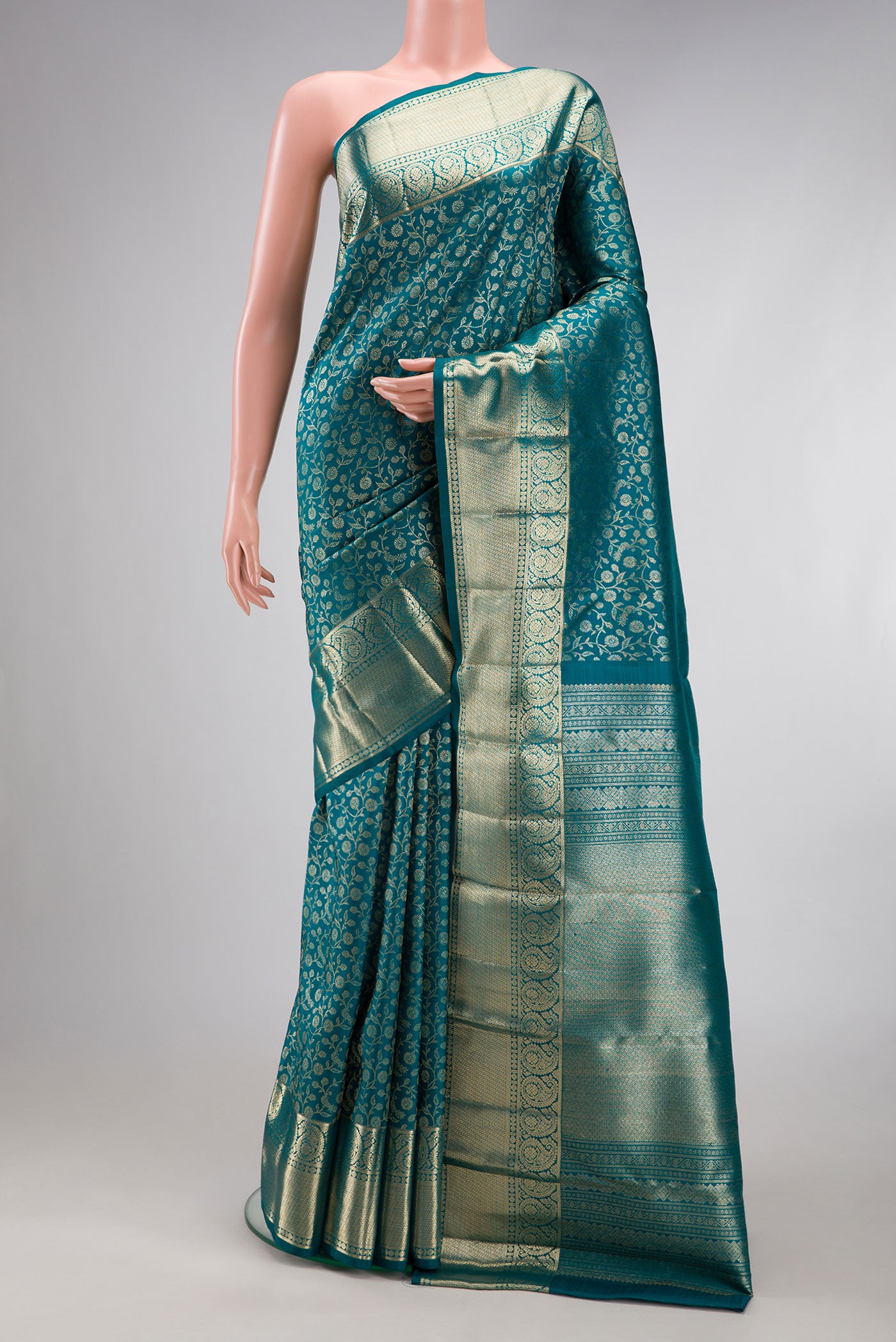Teal Kanchipuram Silk Saree with Zari Brocade on the body and Zari Border.  displayed on a mannequin