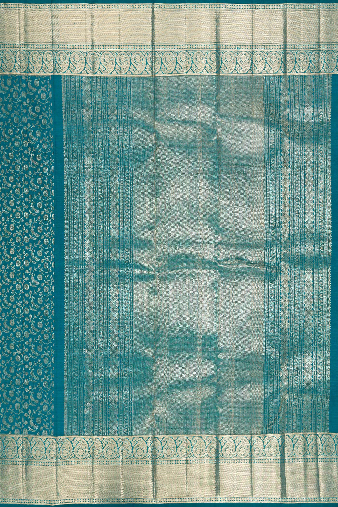 Close up image of the pallu of Teal Kanchipuram Silk Saree with Zari Brocade on the body and Zari Border. 