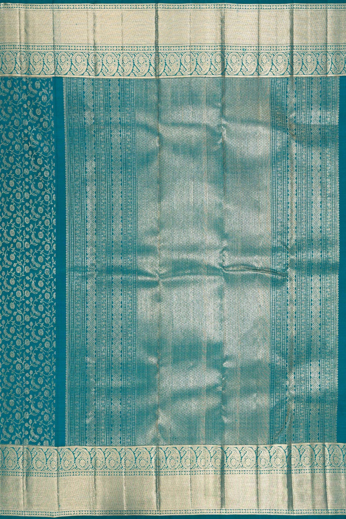 Close up image of the pallu of Teal Kanchipuram Silk Saree with Zari Brocade on the body and Zari Border. 