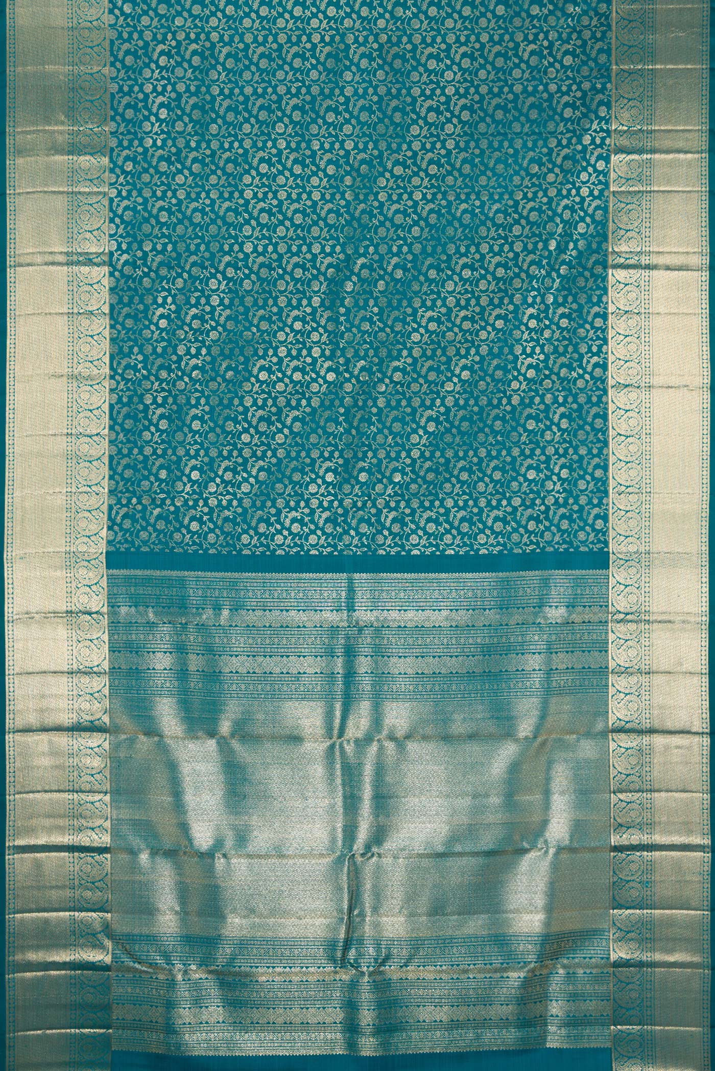 Flat view of Teal Kanchipuram Silk Saree with Zari Brocade on the body and Zari Border. 