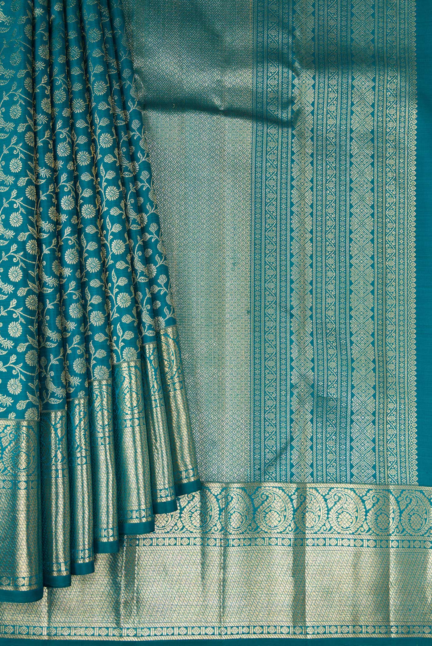 Pleats and pallu of Teal Kanchipuram Silk Saree with Zari Brocade on the body and Zari Border. 