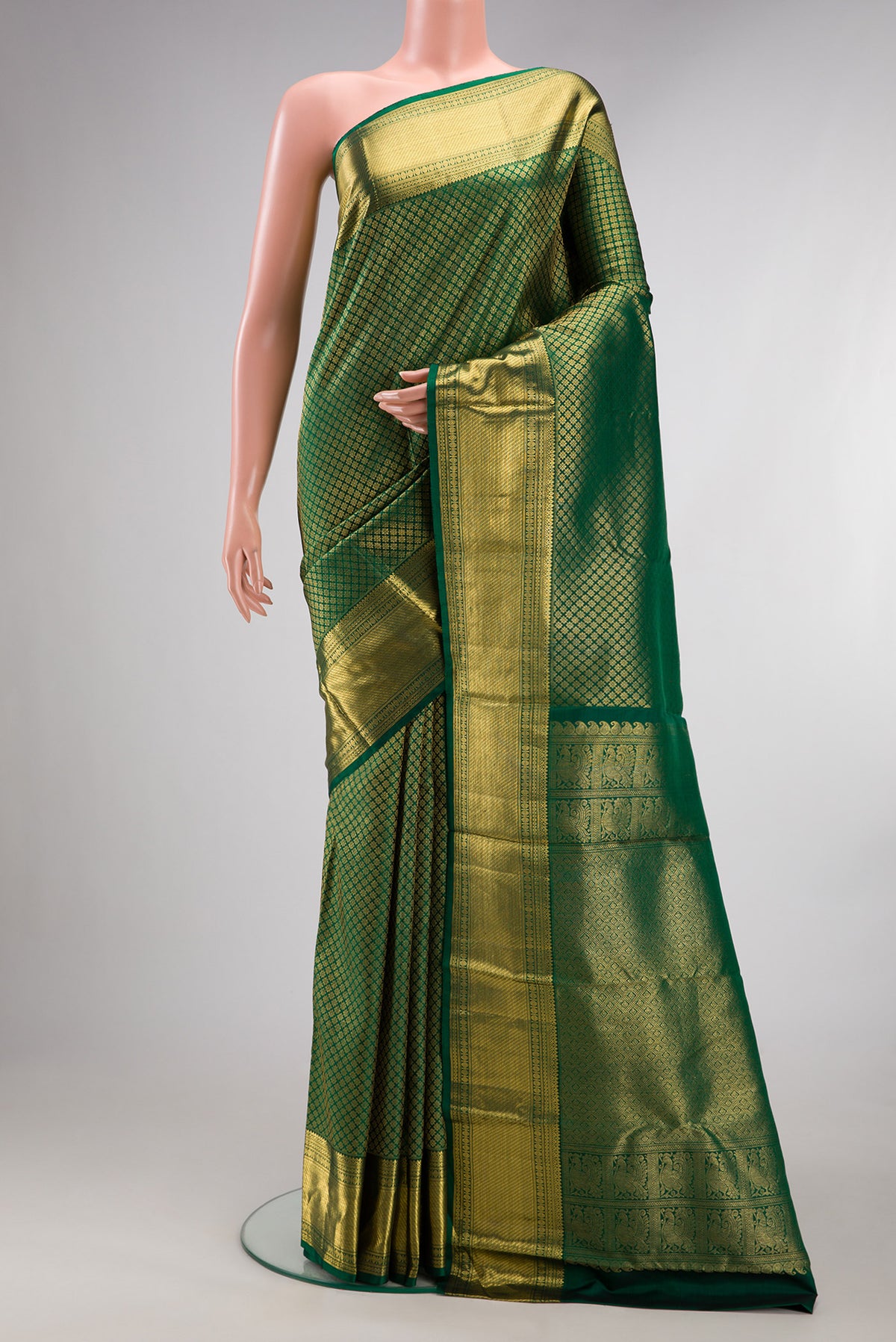 Pure Silk Bottle Green Kanchipuram Saree with Zari Brocade on the body and Zari Border.  displayed on a mannequin