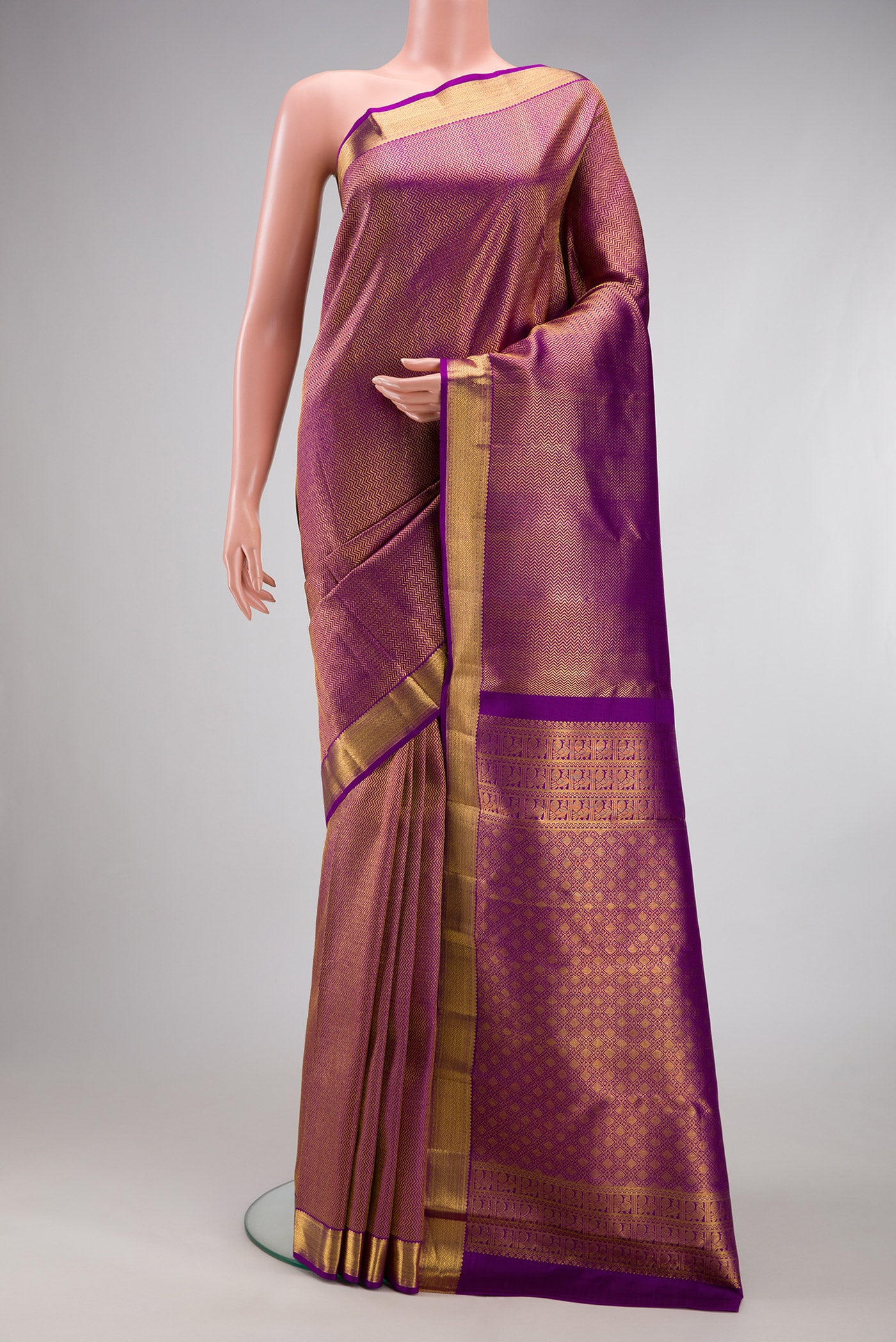 Purple Kanchipuram Silk Saree with Zari Brocade on the body and Zari Border.  displayed on a mannequin