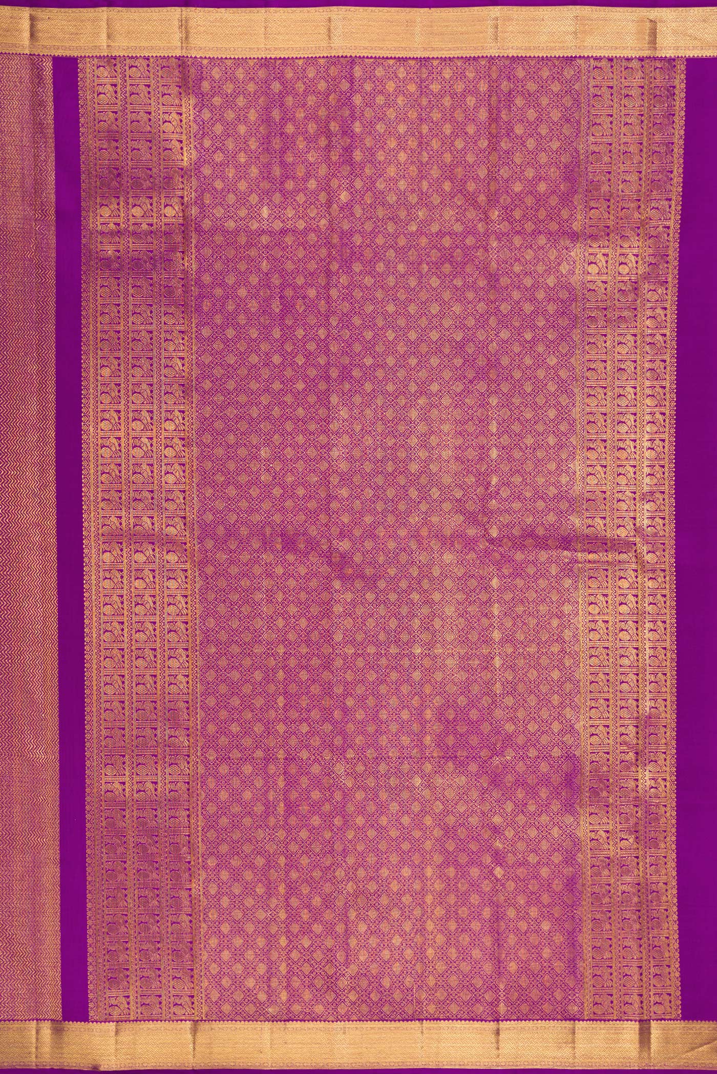 Close up image of the pallu of Purple Kanchipuram Silk Saree with Zari Brocade on the body and Zari Border. 