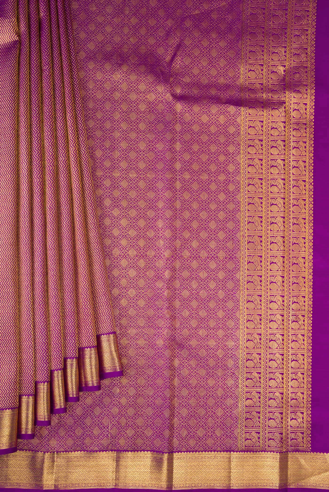 Pleats and pallu of Purple Kanchipuram Silk Saree with Zari Brocade on the body and Zari Border. 