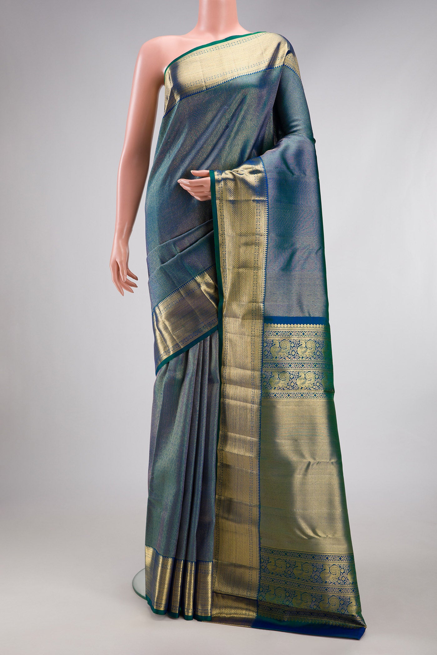 Peacock Blue Dual Tone Kanchipuram Silk Saree with Zari Brocade on the body and Zari Border.  displayed on a mannequin