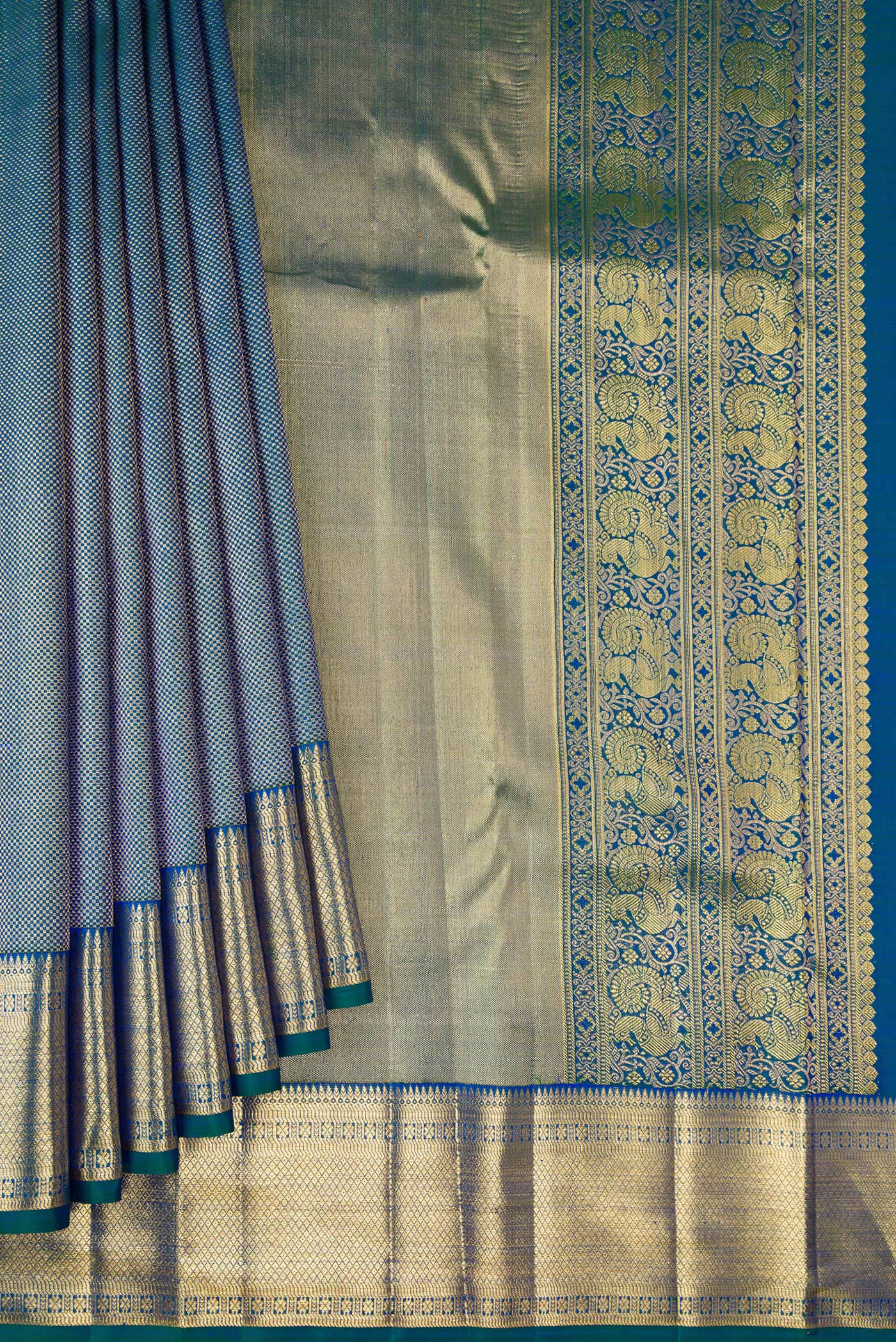 Pleats and pallu of Peacock Blue Dual Tone Kanchipuram Silk Saree with Zari Brocade on the body and Zari Border. 