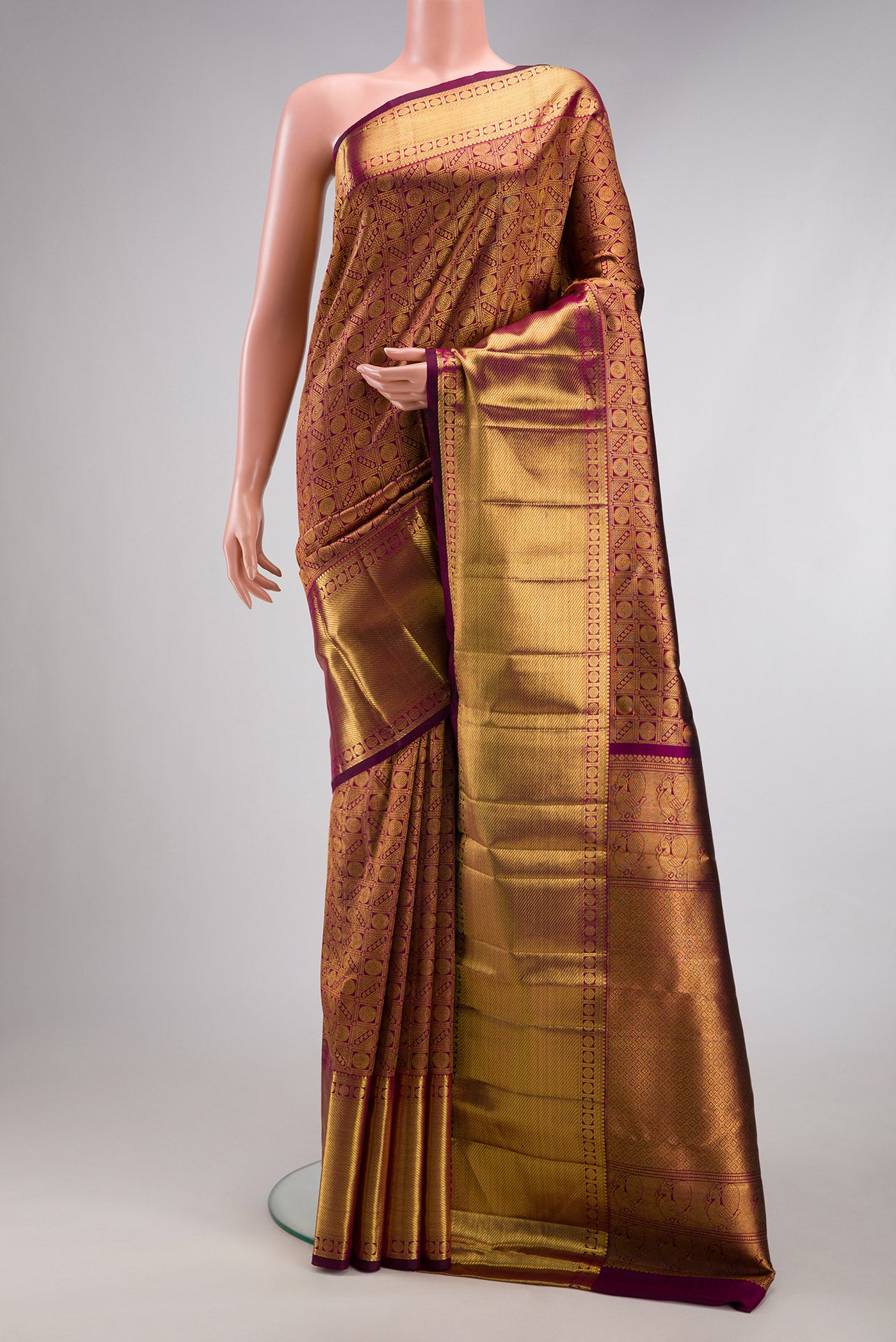 Magenta Dual Tone Kanchipuram Silk Saree with Zari Brocade on the body and Zari Border.  displayed on a mannequin