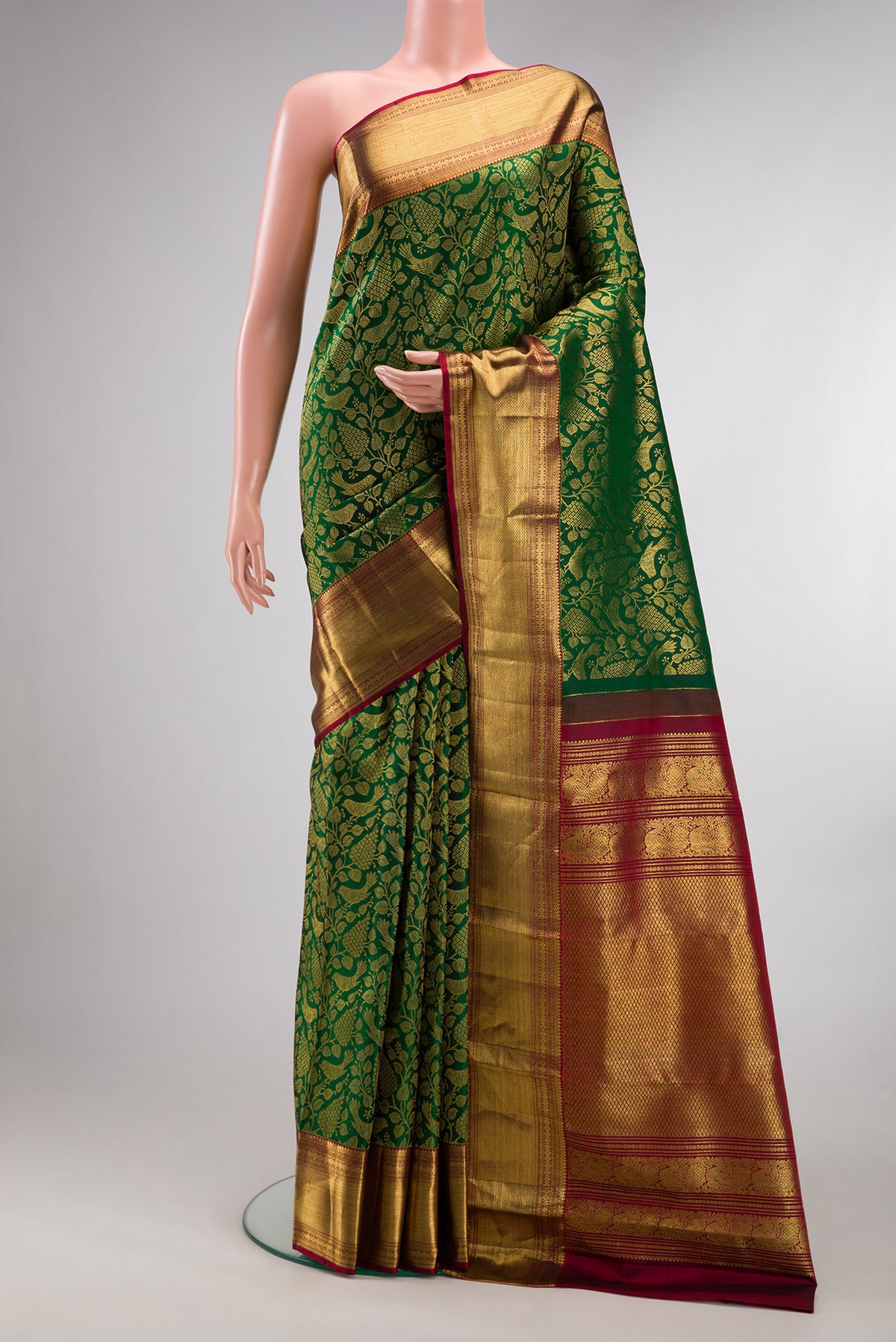 Pure Silk Bottle Green Kanchipuram Saree with Zari Brocade on the body and Zari Border.  displayed on a mannequin