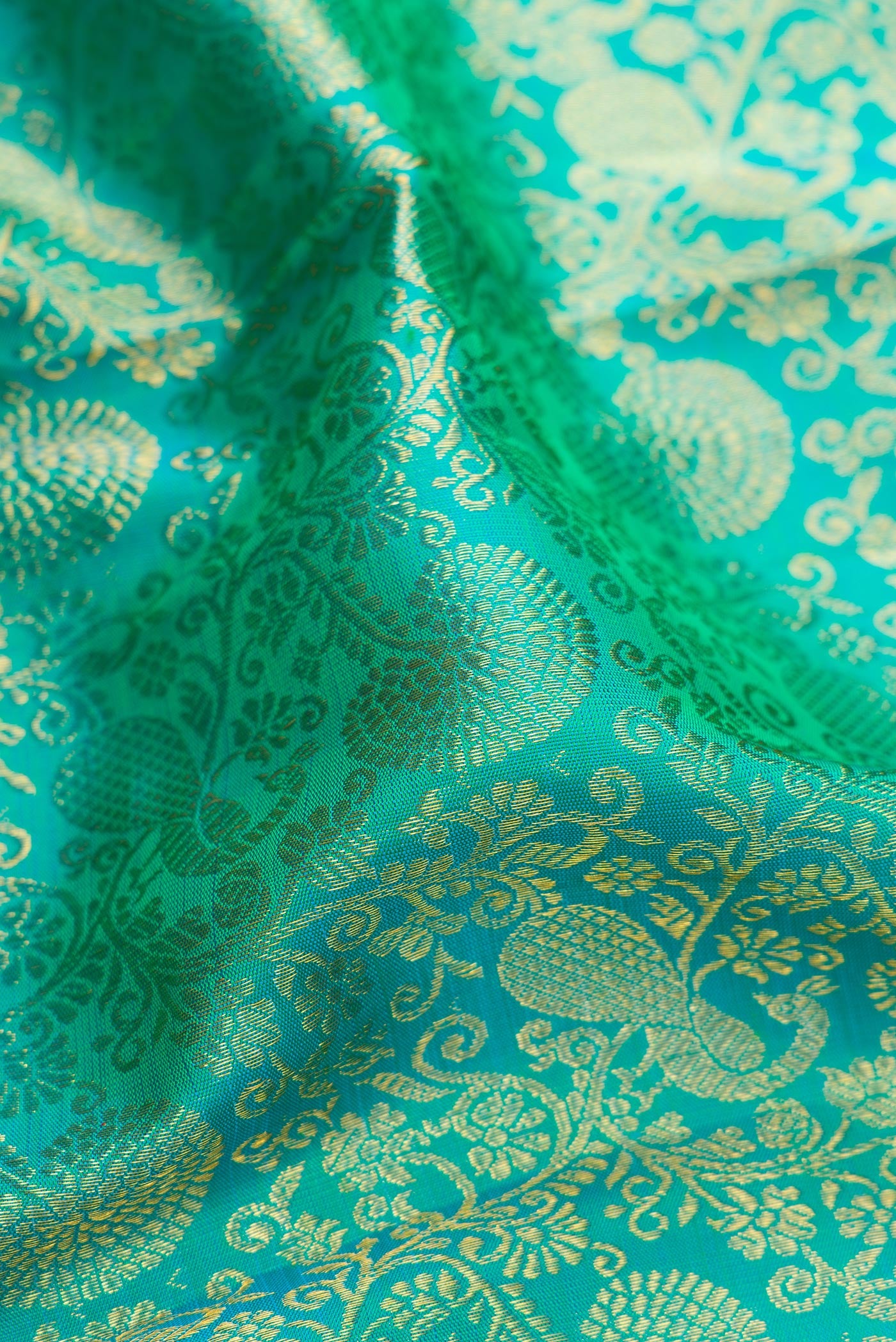 Close up of Sea Green Dual Tone Kanchipuram Silk Saree with Zari Brocade on the body and Zari Border.  displaying folds