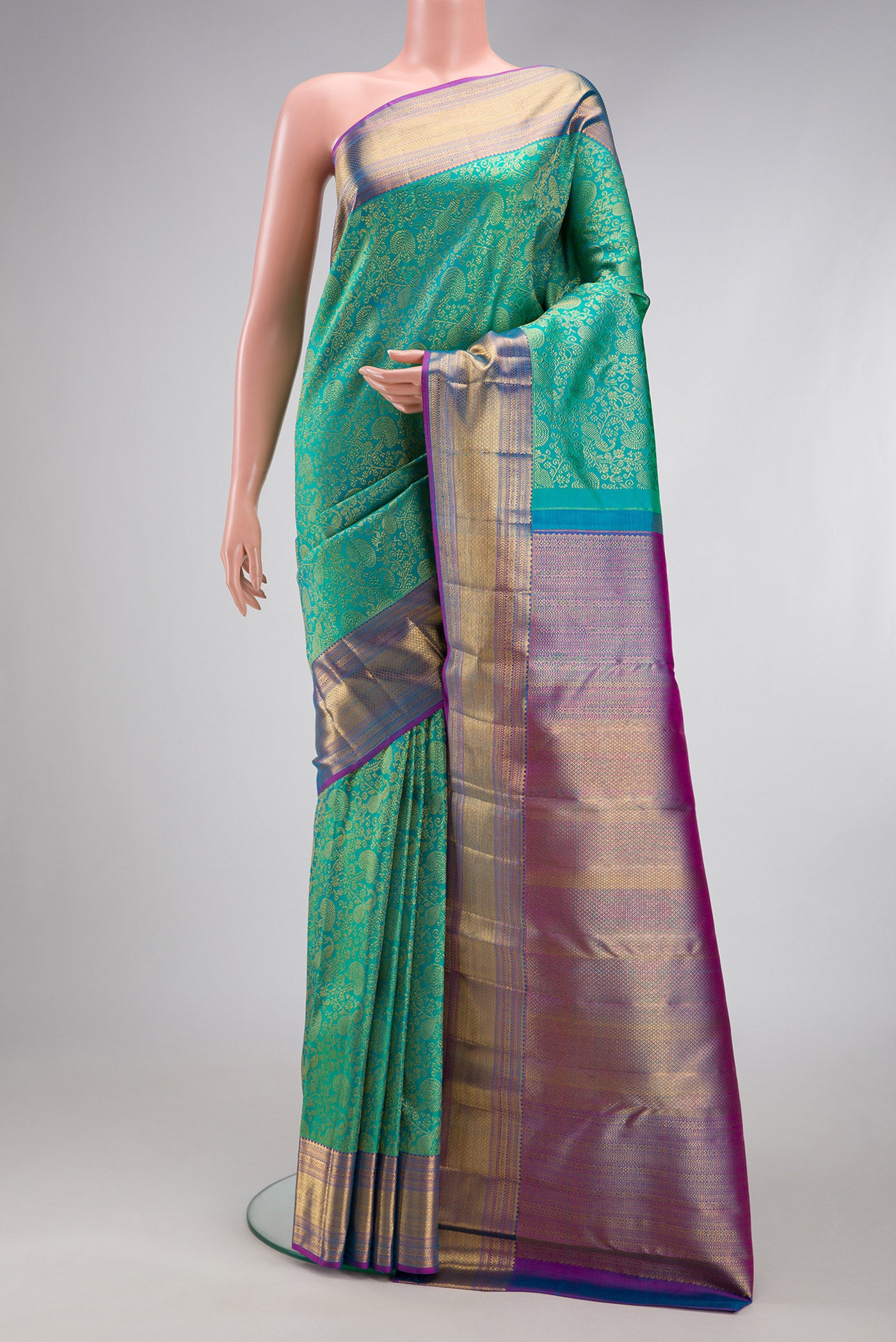 Sea Green Dual Tone Kanchipuram Silk Saree with Zari Brocade on the body and Zari Border.  displayed on a mannequin
