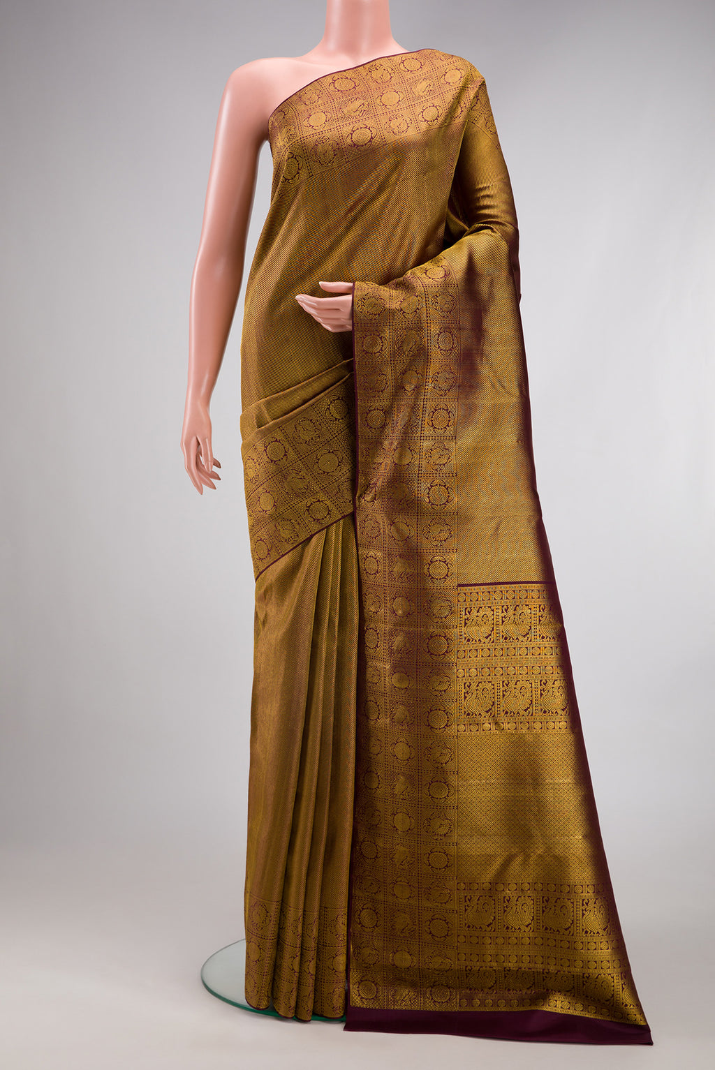 Coffee Brown Kanchipuram Silk Saree with Zari Brocade on the body and Fancy Border.  displayed on a mannequin