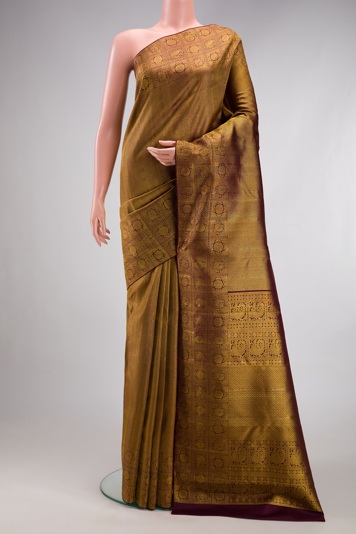 Coffee Brown Kanchipuram Silk Saree with Zari Brocade on the body and Fancy Border.  displayed on a mannequin