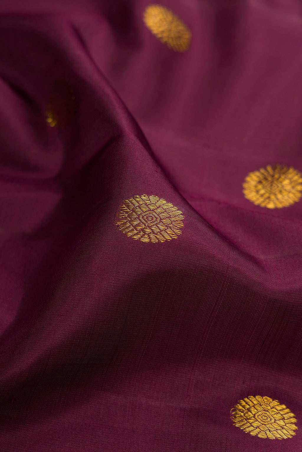 Close up of Coffee Brown Kanchipuram Silk Saree with Zari Butta on the body and Fancy Border.  displaying folds