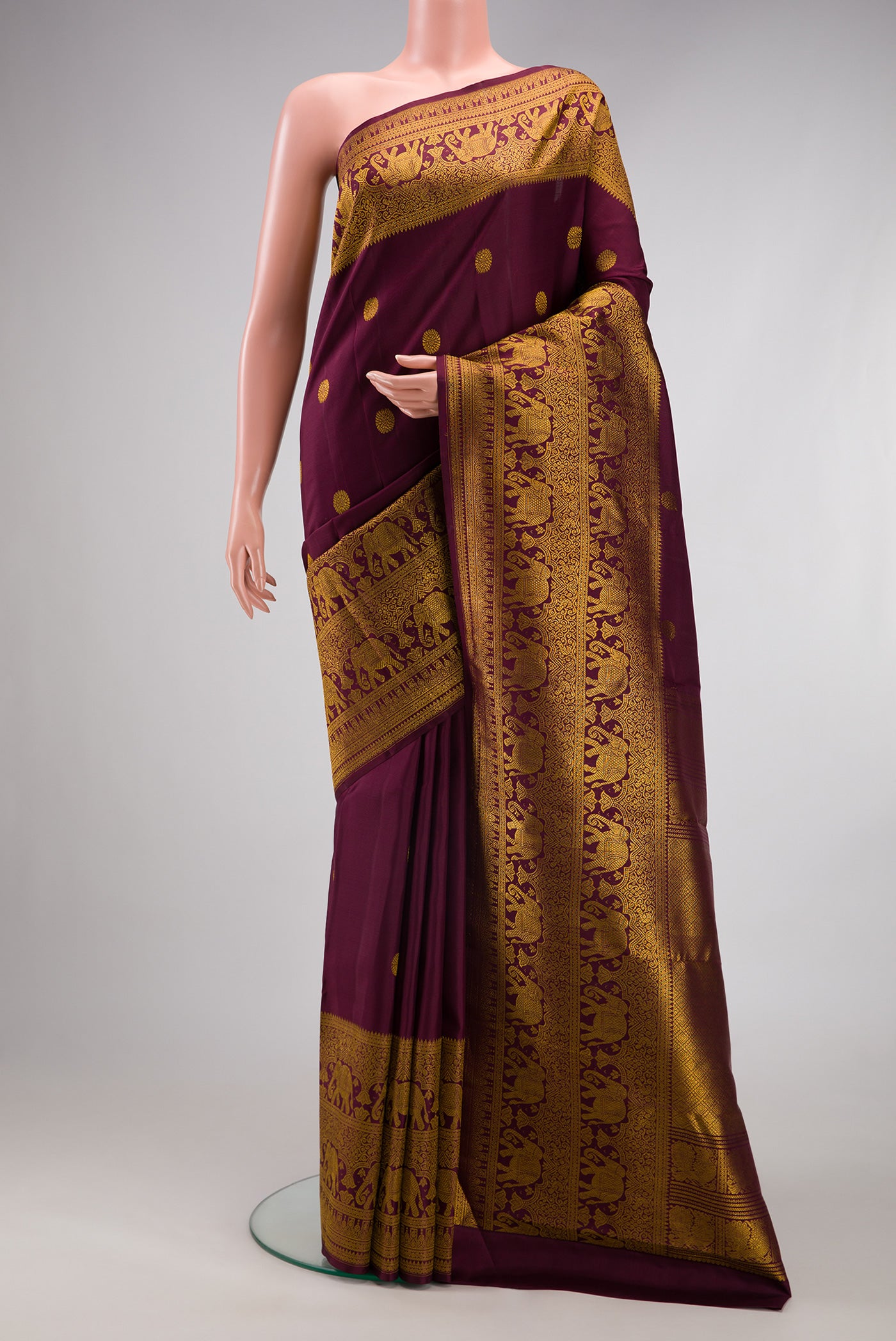 Coffee Brown Kanchipuram Silk Saree with Zari Butta on the body and Fancy Border.  displayed on a mannequin