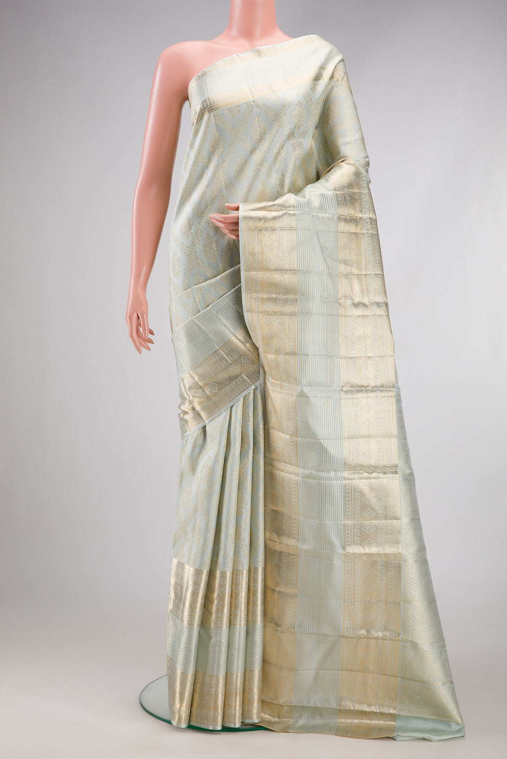 Light Blue Kanchipuram Silk Saree with Zari Brocade on the body and Fancy Border.  displayed on a mannequin